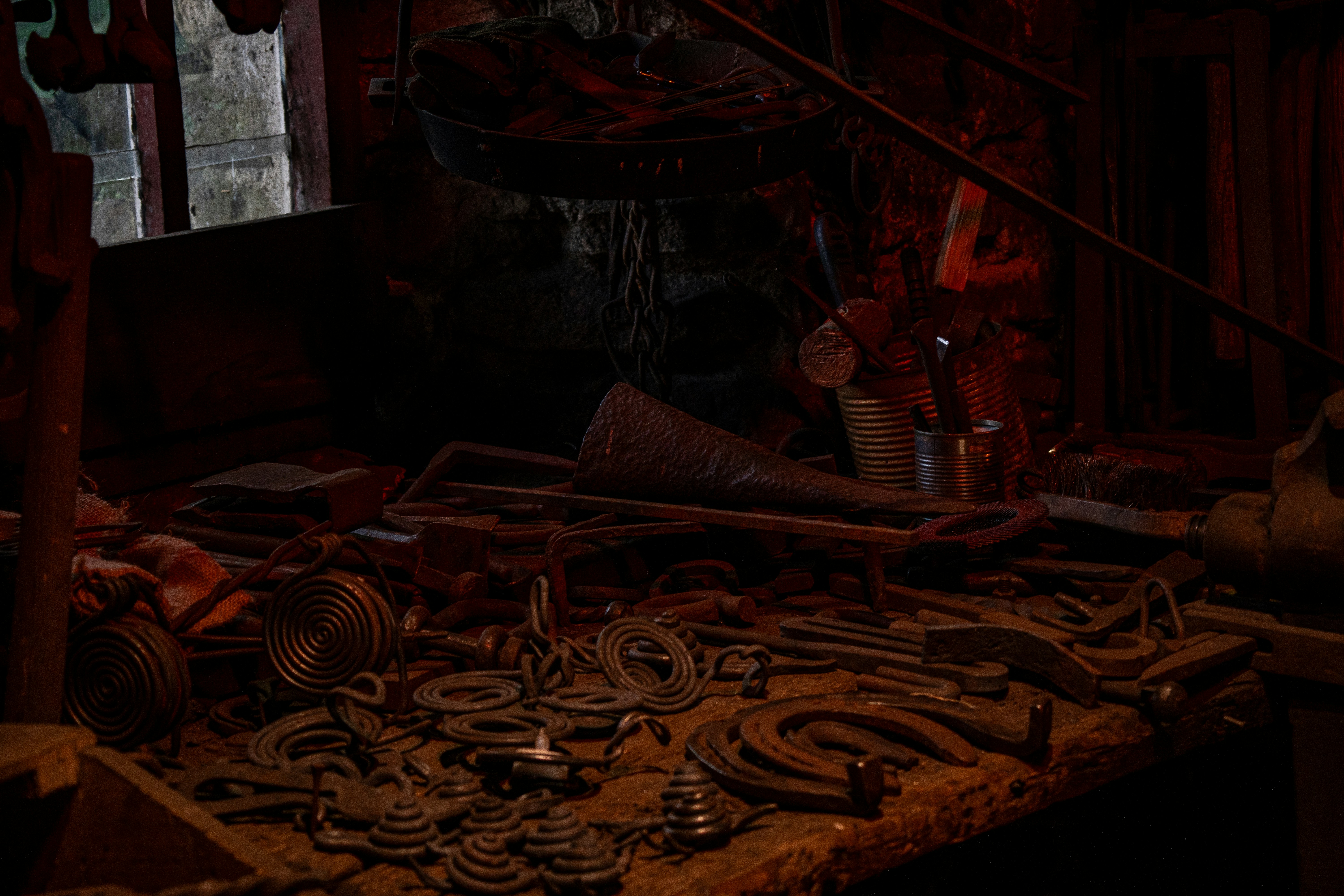 Warm shadows dance over iron forms, whispering of hands that shaped history. Every twist and curve in the blacksmith’s forge feels alive—a symphony of metal, memory, and firelight. 🔩