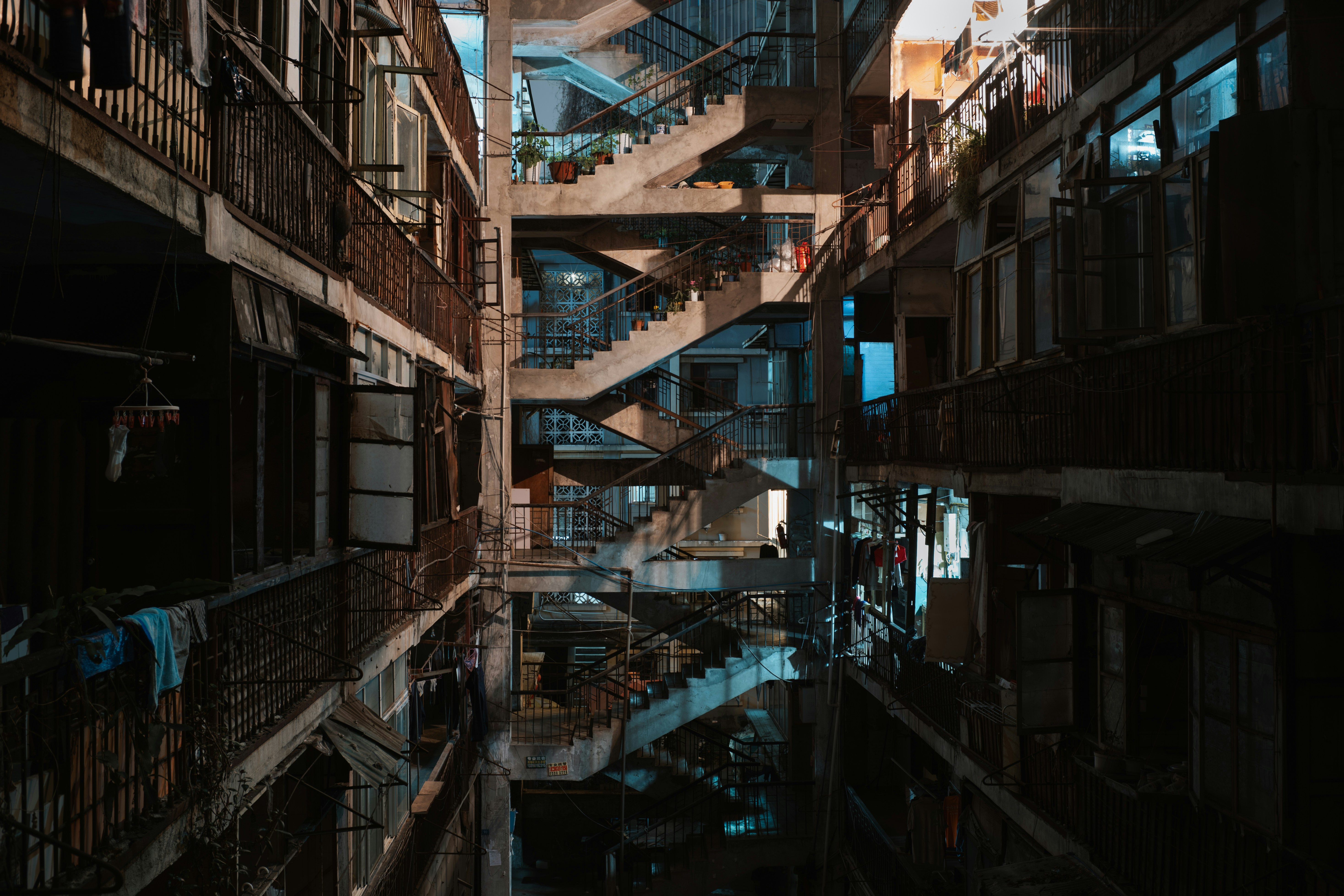 Interior view of a dimly lit, multi-story apartment building
