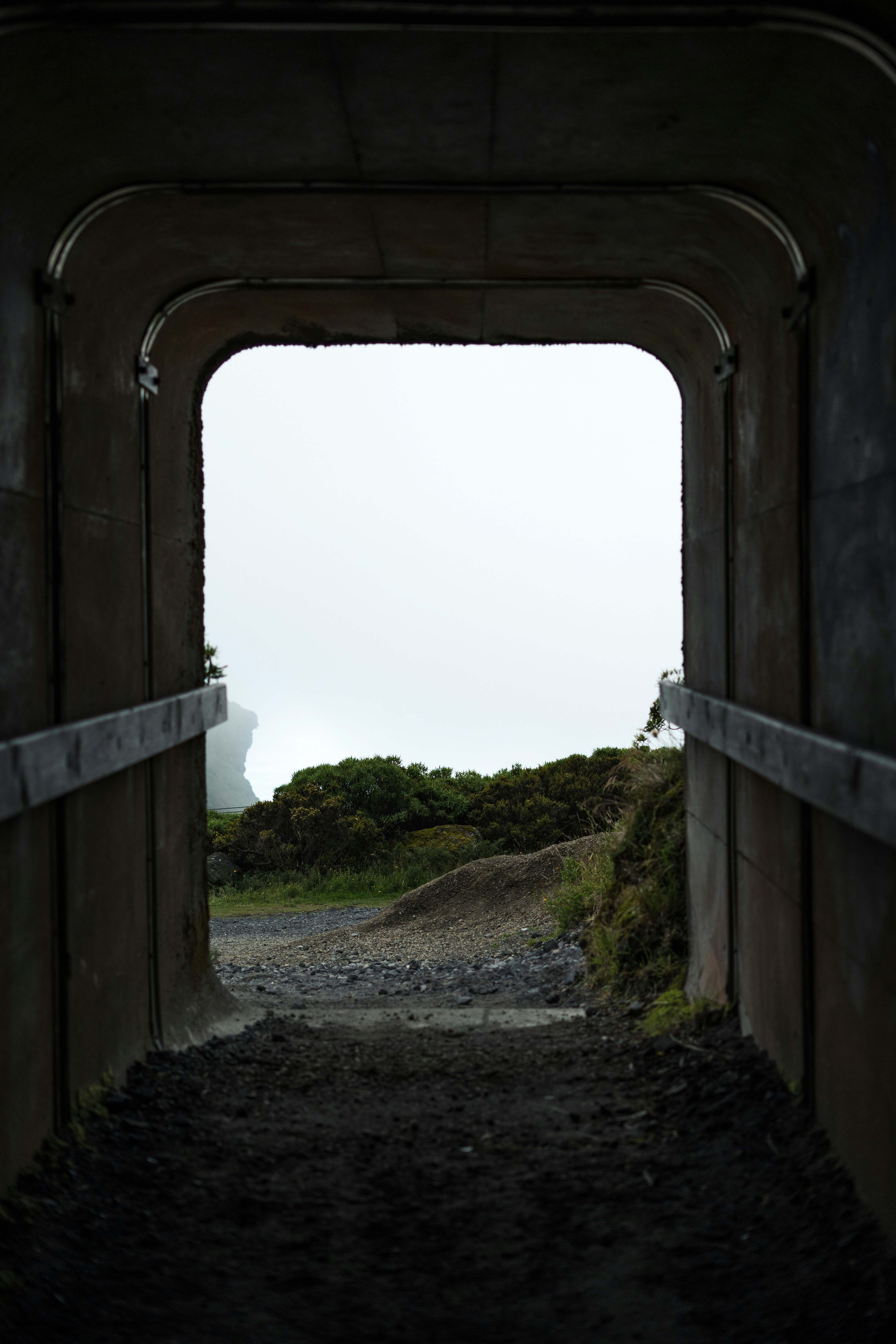 View through a tunnel of a foggy landscape