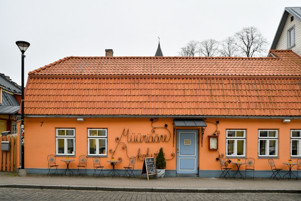 Orange building with blue door and outdoor seating — Haapsalu, Estonia