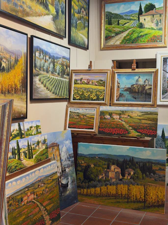Collection of landscape paintings displayed indoors