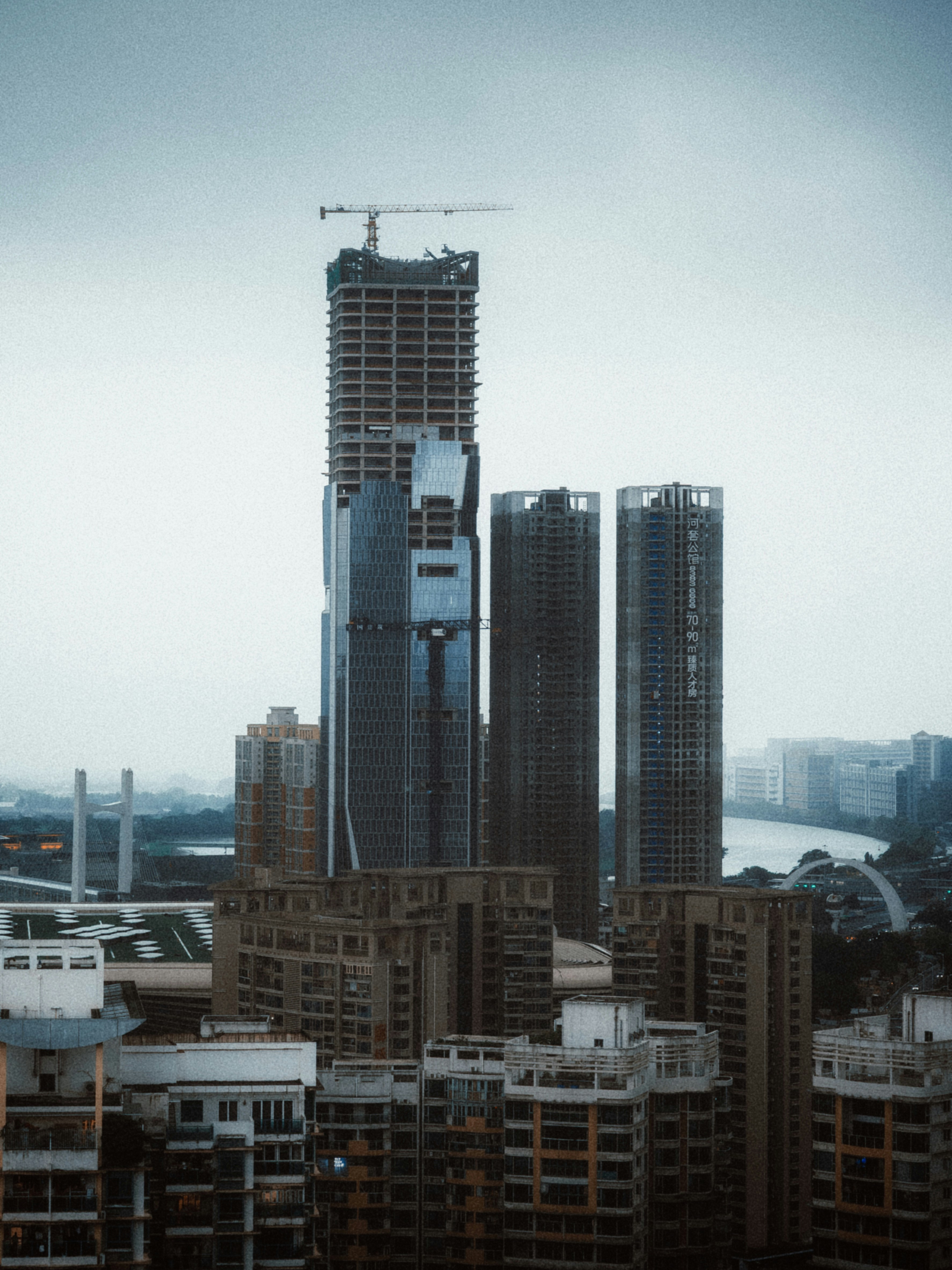 Skyscrapers under construction against a cloudy sky