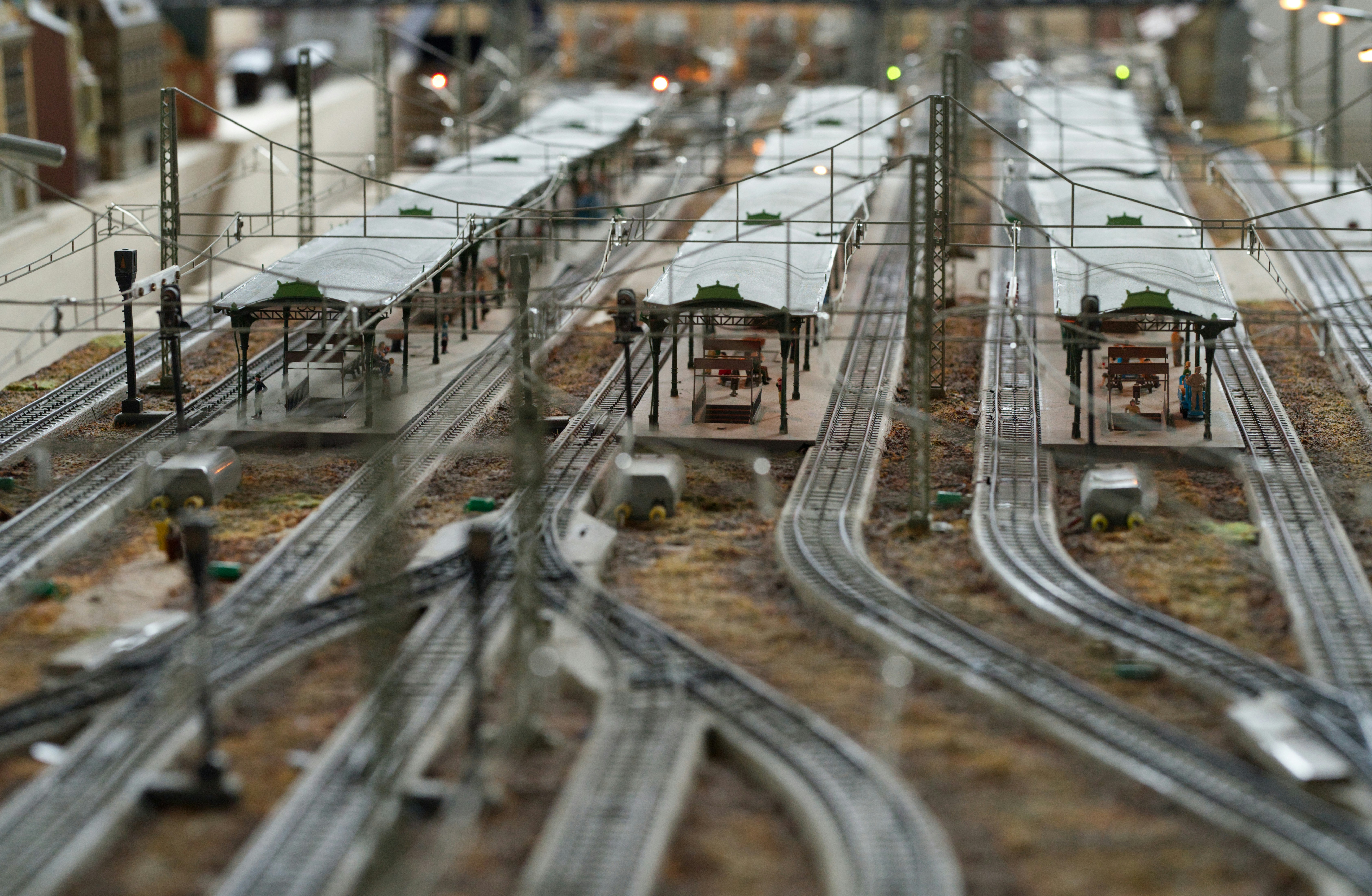 Model train station with multiple tracks and platforms