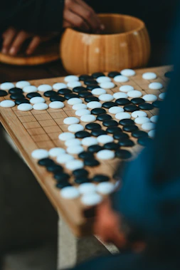 People playing go with black and white stones on board
