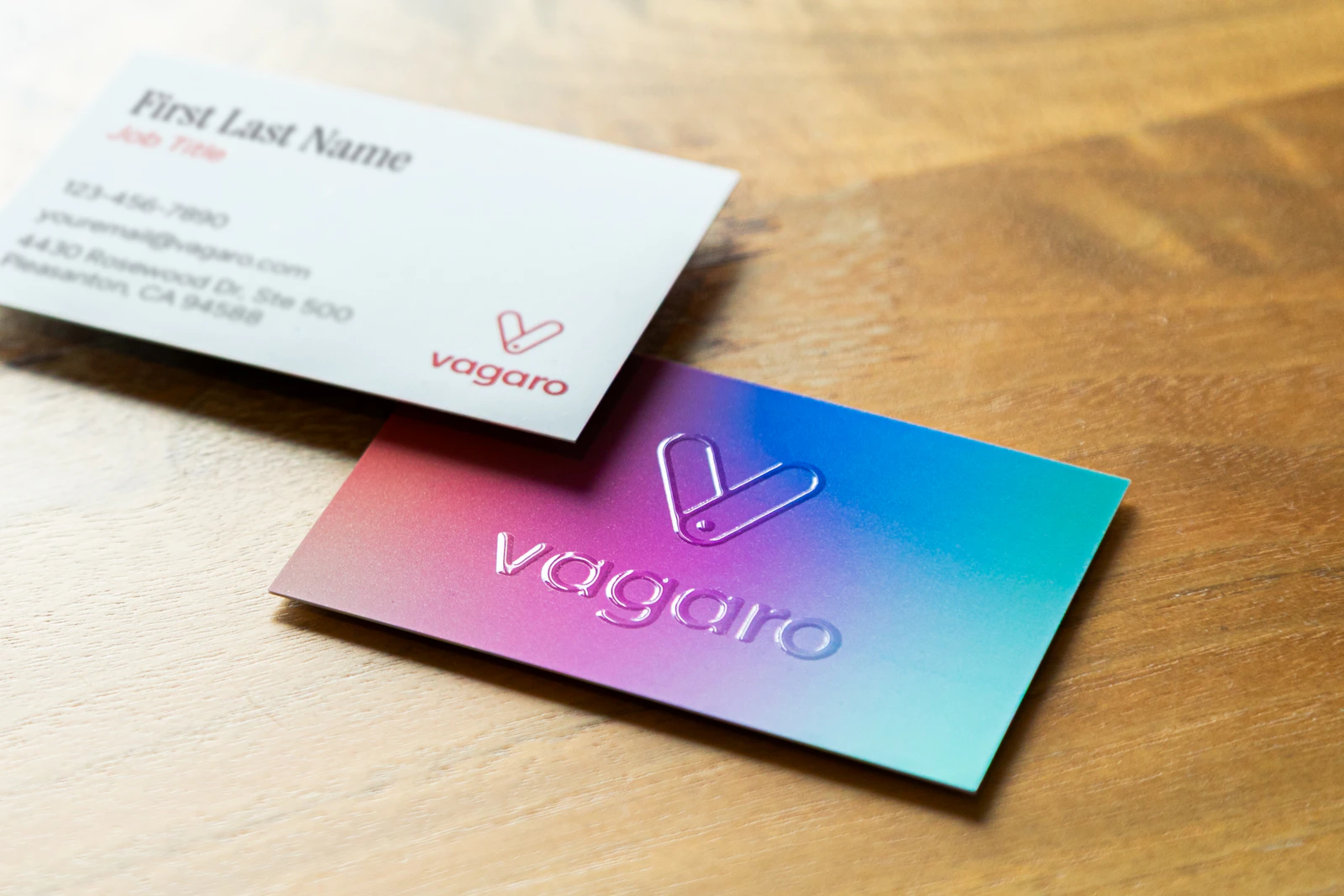 Professional branded business cards and identity materials arranged as corporate stationery