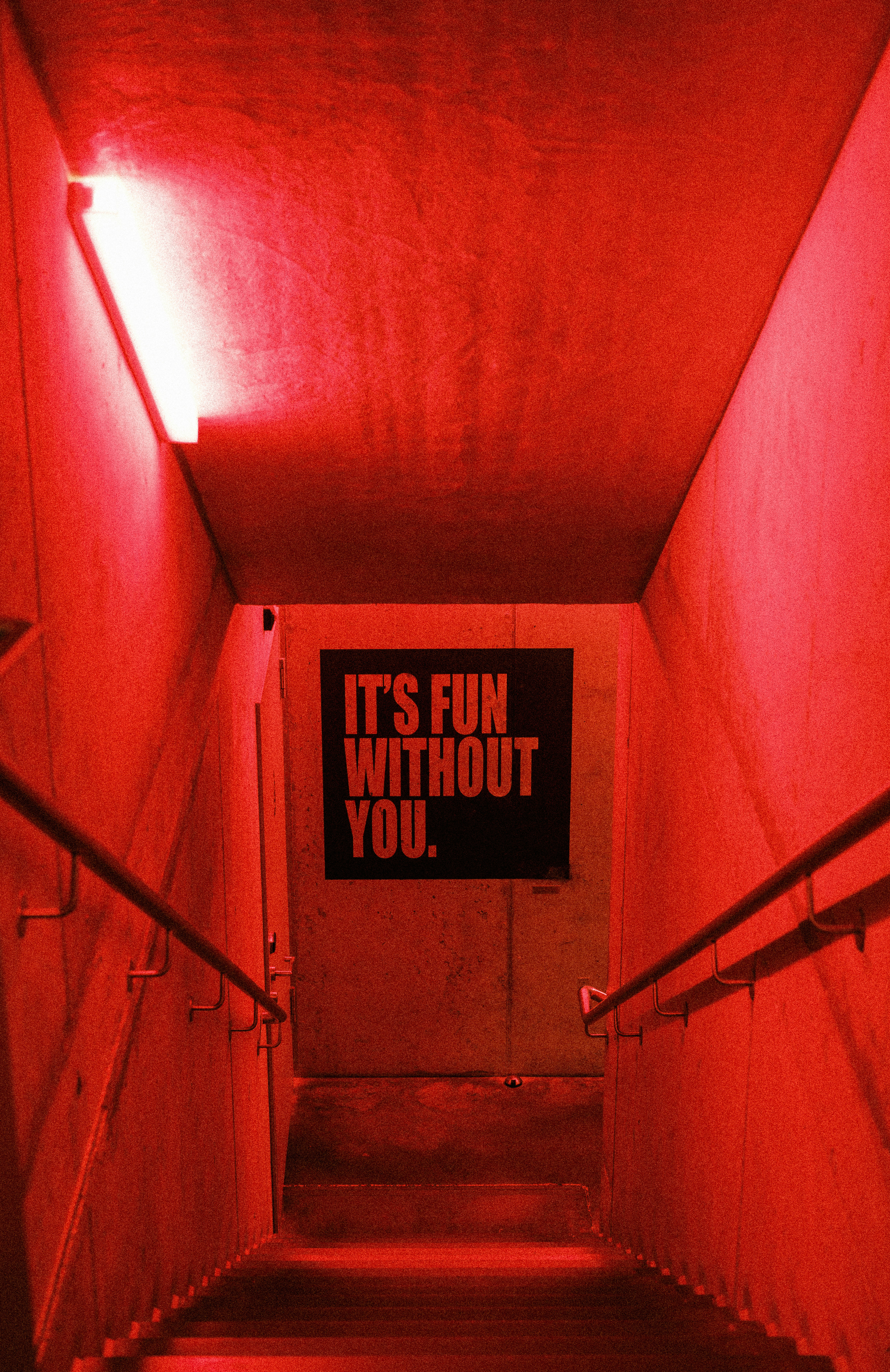 Stairs illuminated with red light and a sign