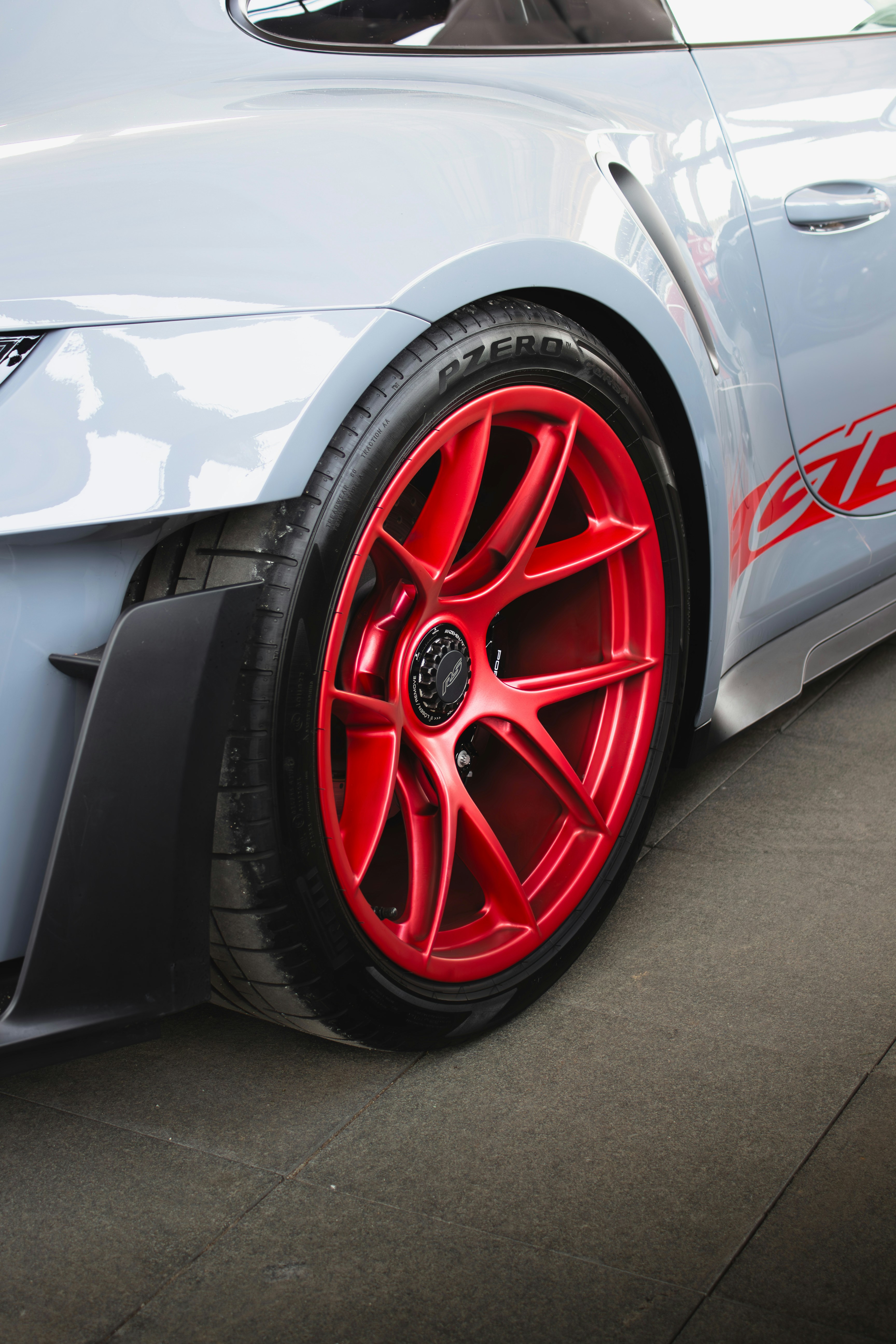 Red wheel on a grey sports car