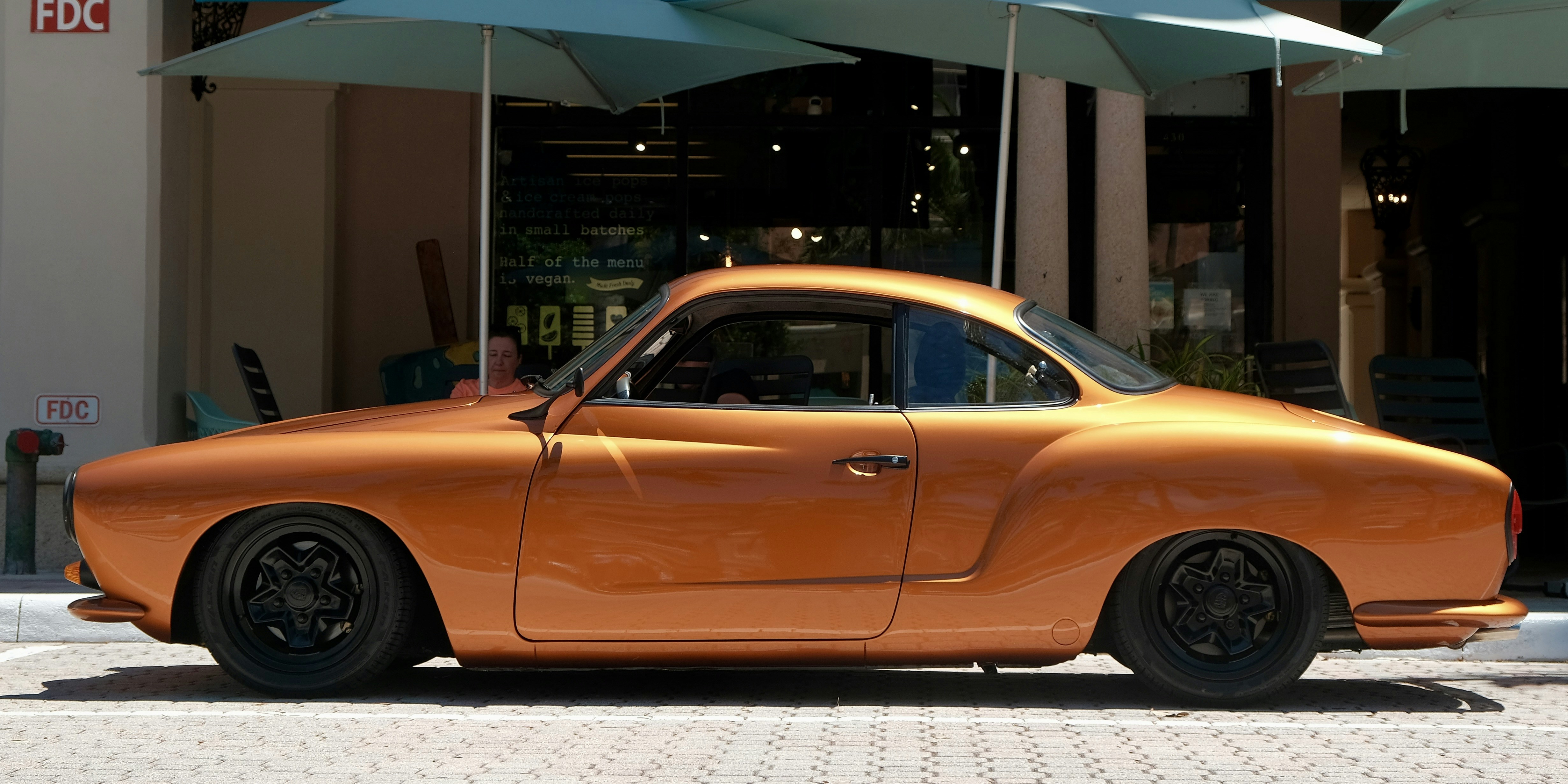 Orange vintage car parked on the street