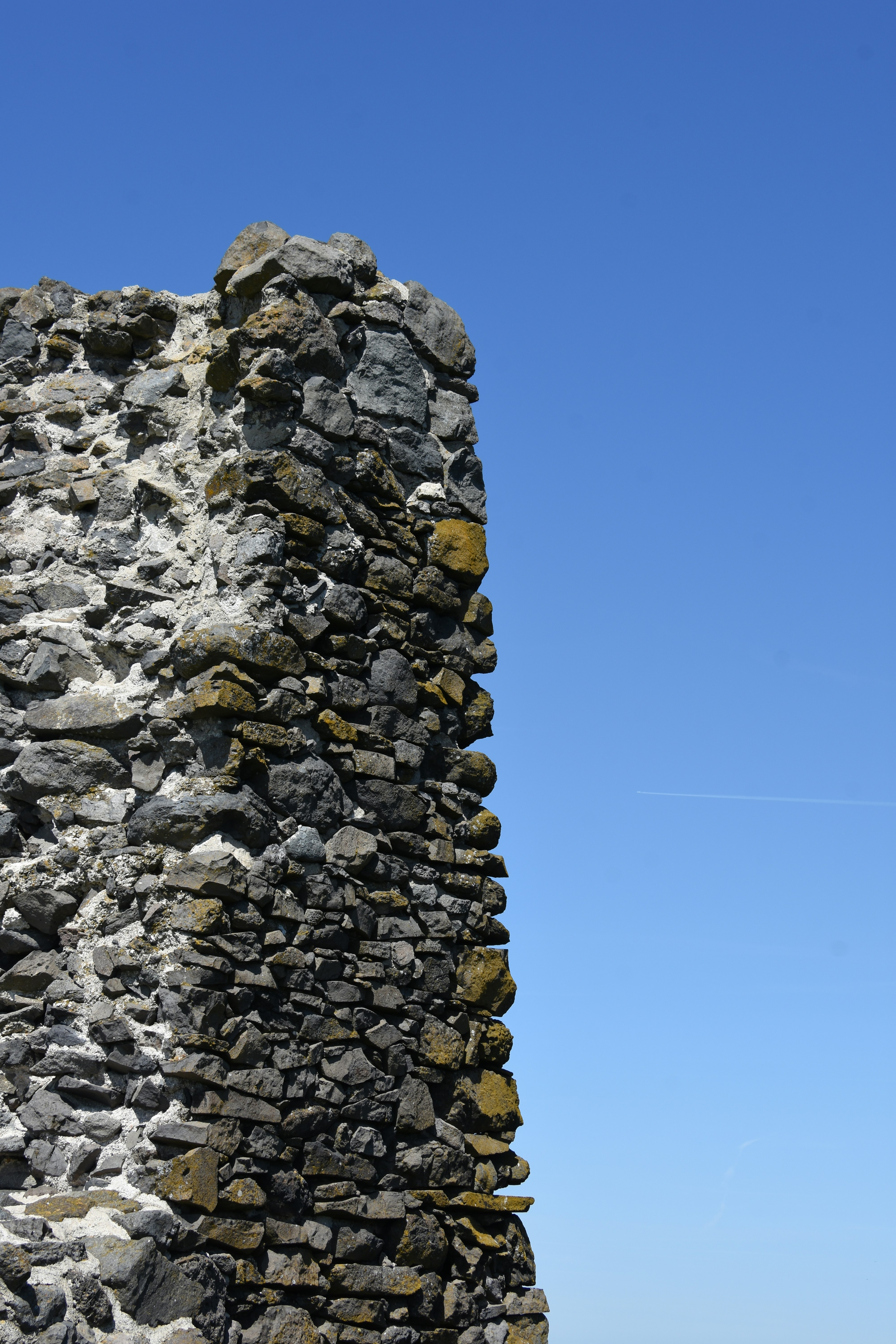 Ancient stone ruin against a clear blue sky