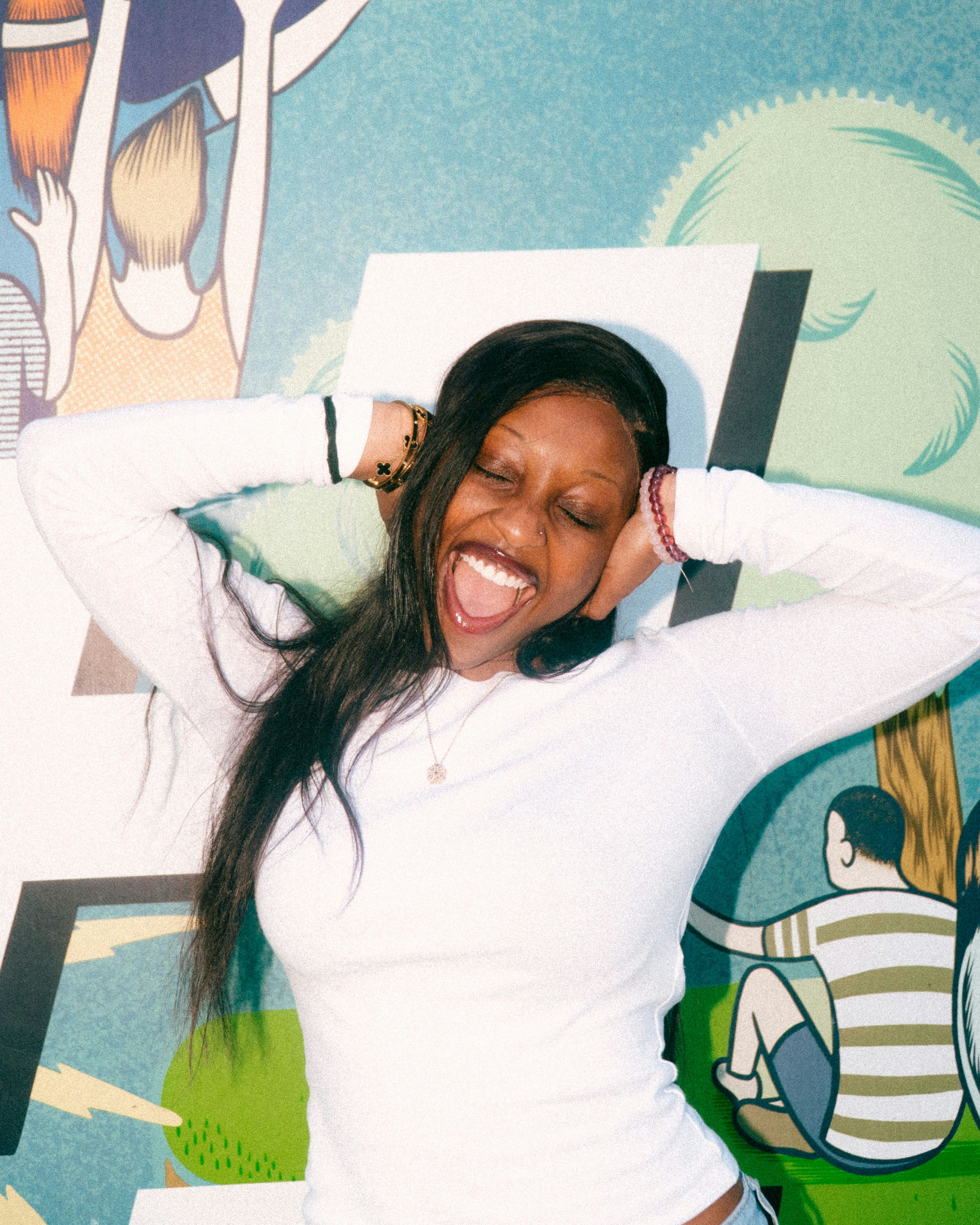 Woman with hands on head laughing with joy