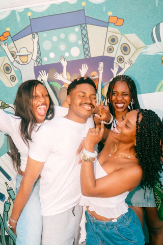 Four friends posing and laughing together