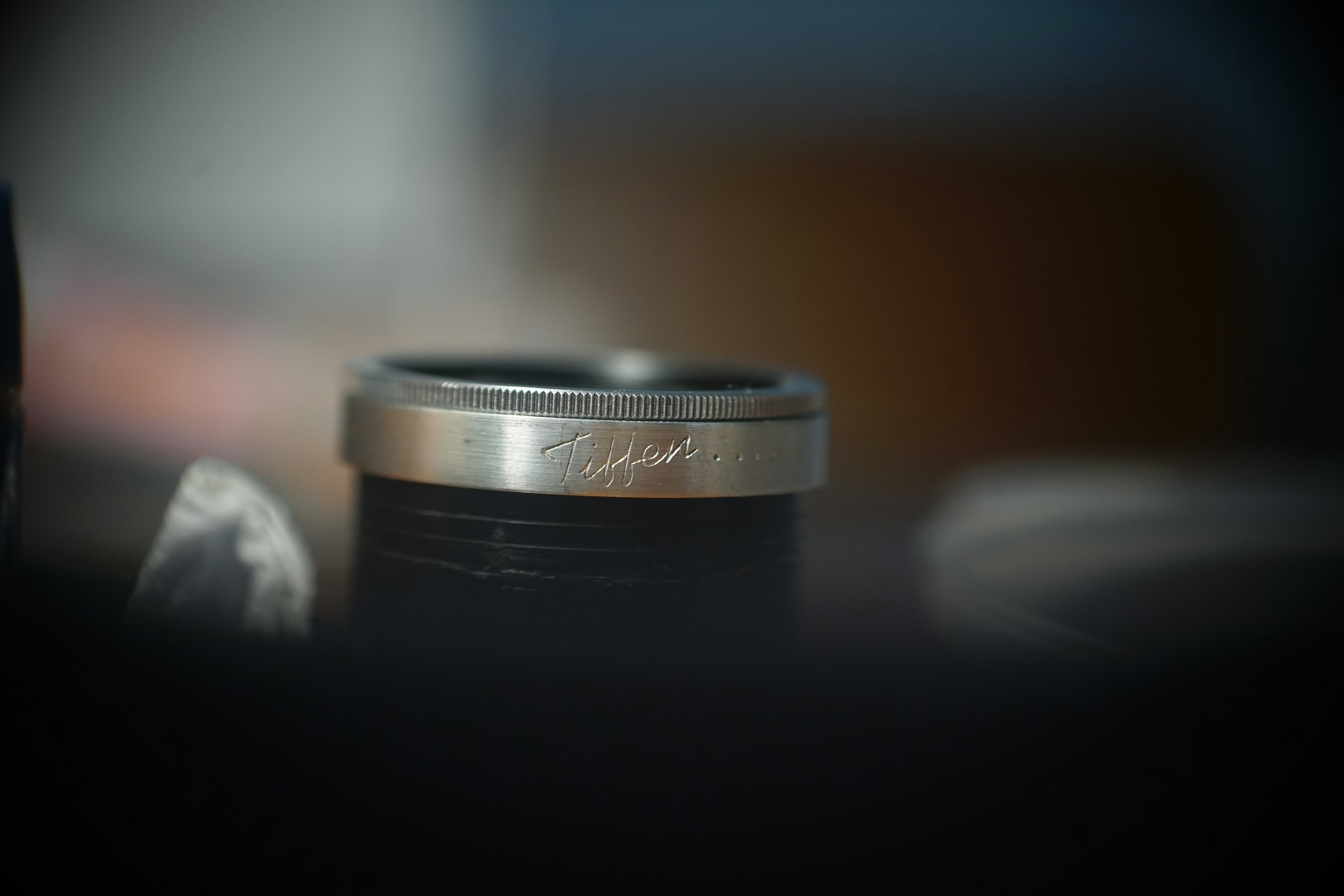 A close-up of a silver ring with inscription