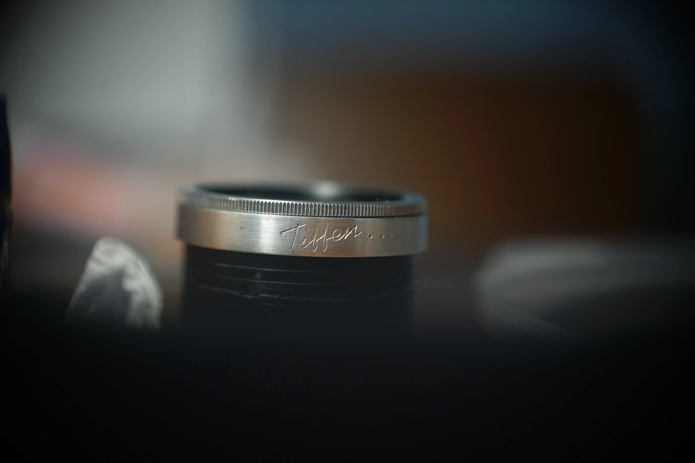 Close-up of a silver band with a handwritten-style engraving