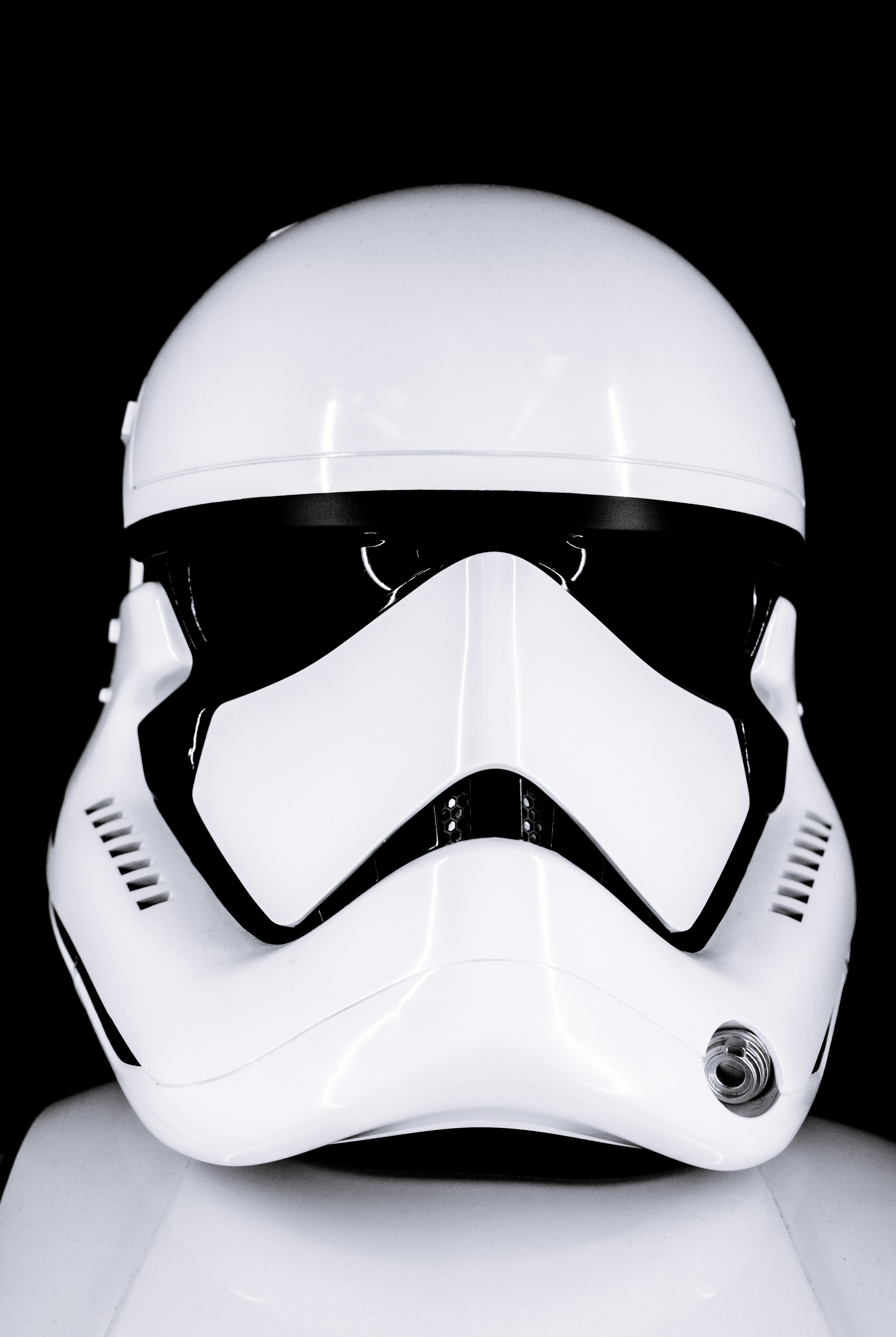 A white stormtrooper helmet against a black background