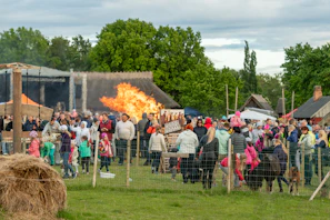 Crowd watches large bonfire at outdoor festival