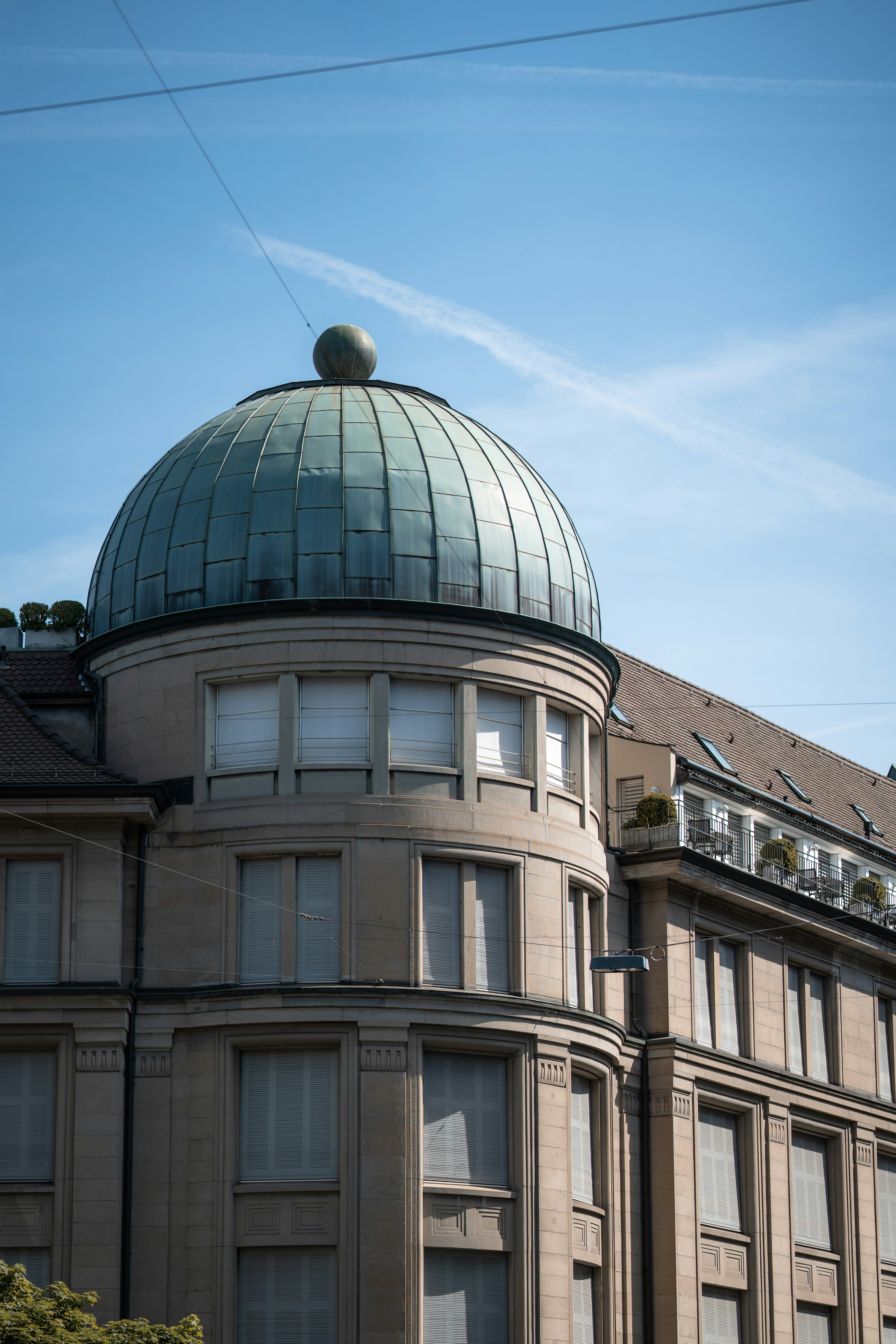 A building with a green dome under a blue sky