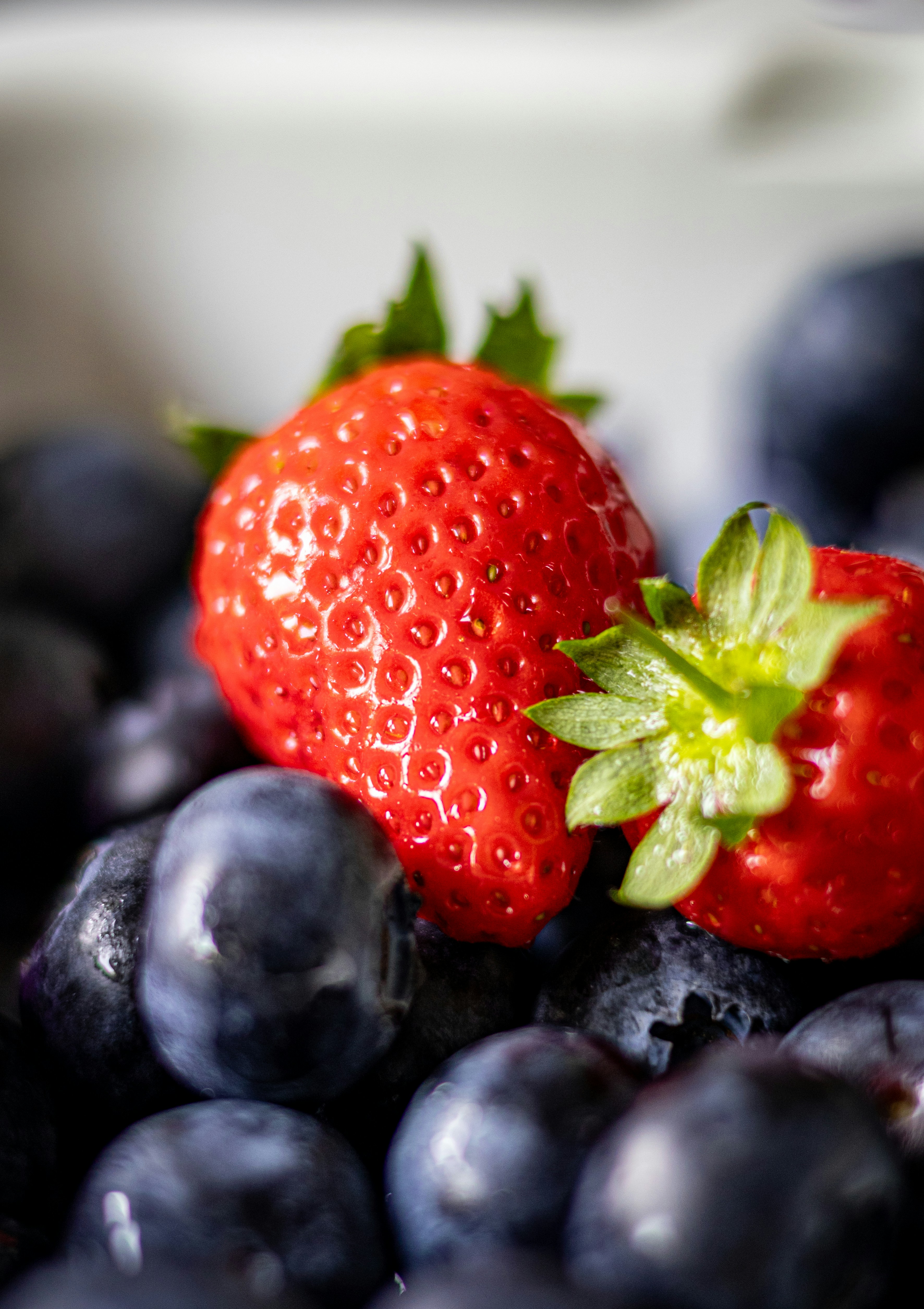summer healthy living — Fresh strawberries and blueberries in a bowl.. Photo: Unsplash