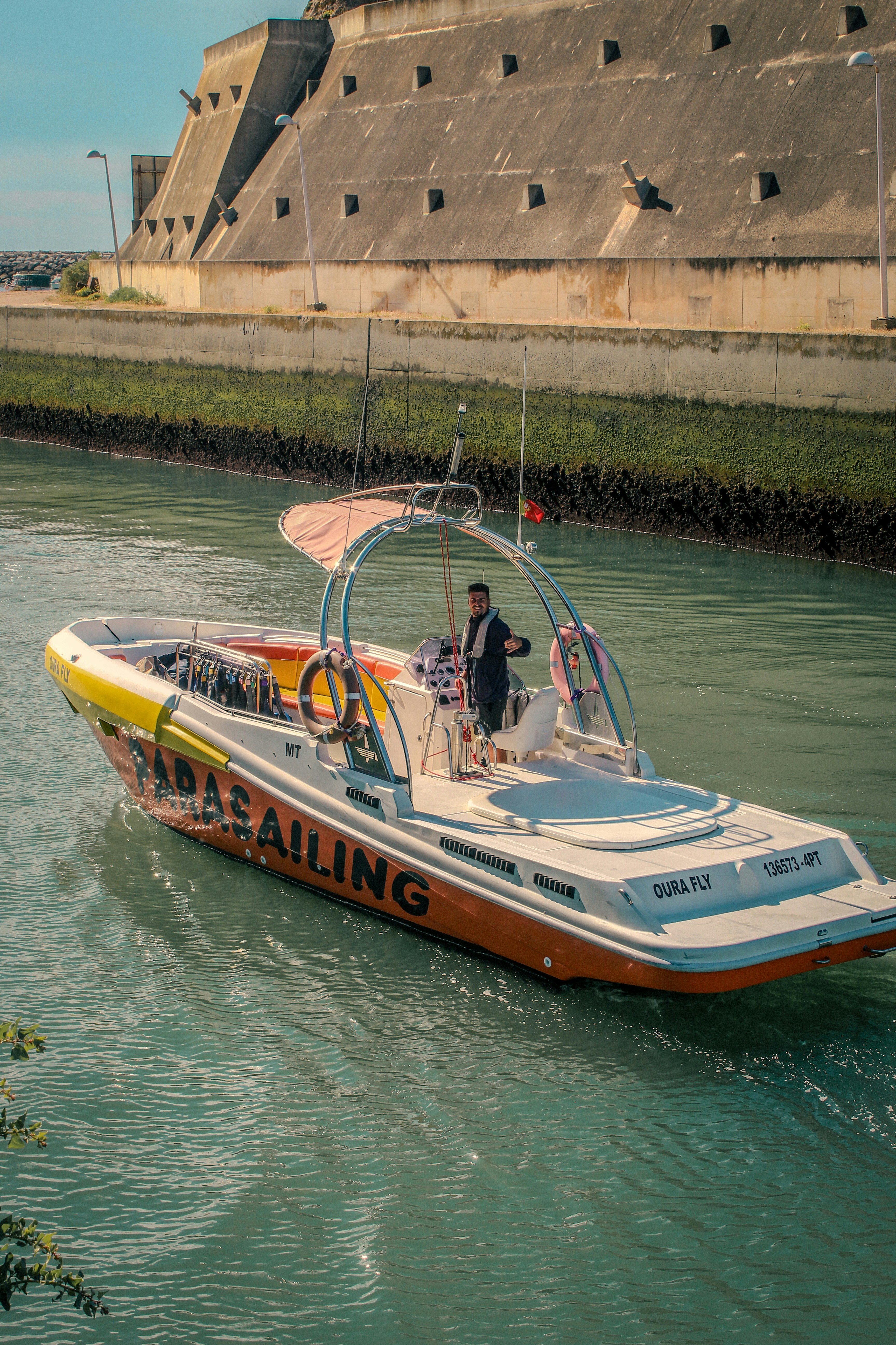 Man piloting a speed boat on a canal