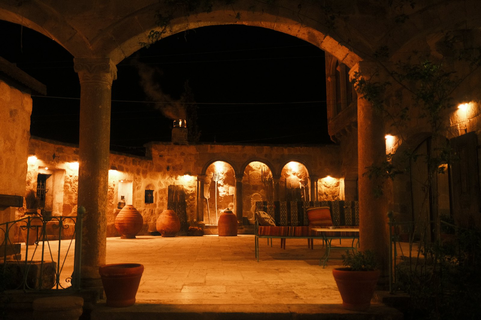 Warmly lit arrival pathway at a tourism property after dark