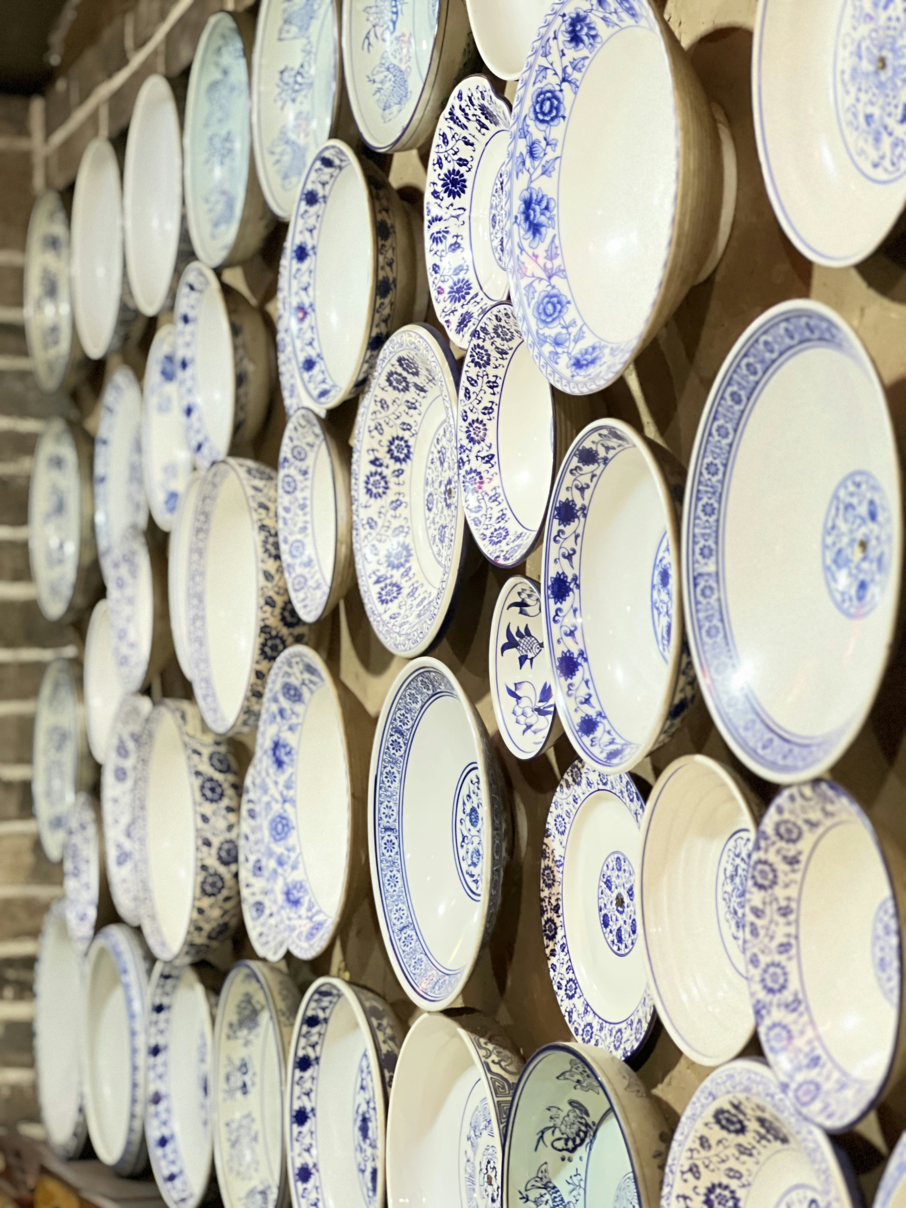 Wall of decorative blue and white porcelain plates.