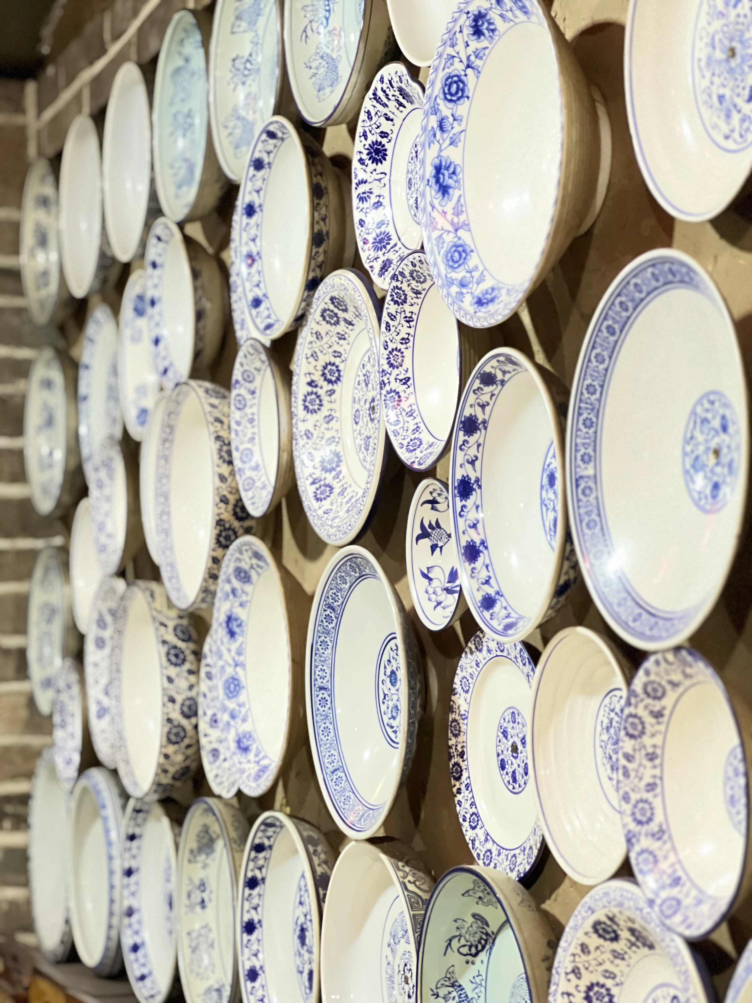 Blue-and-white porcelain plates displayed as an interior art wall