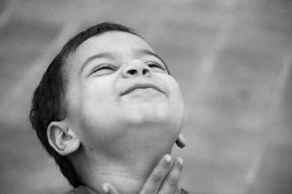 A young boy looking up with a joyful expression