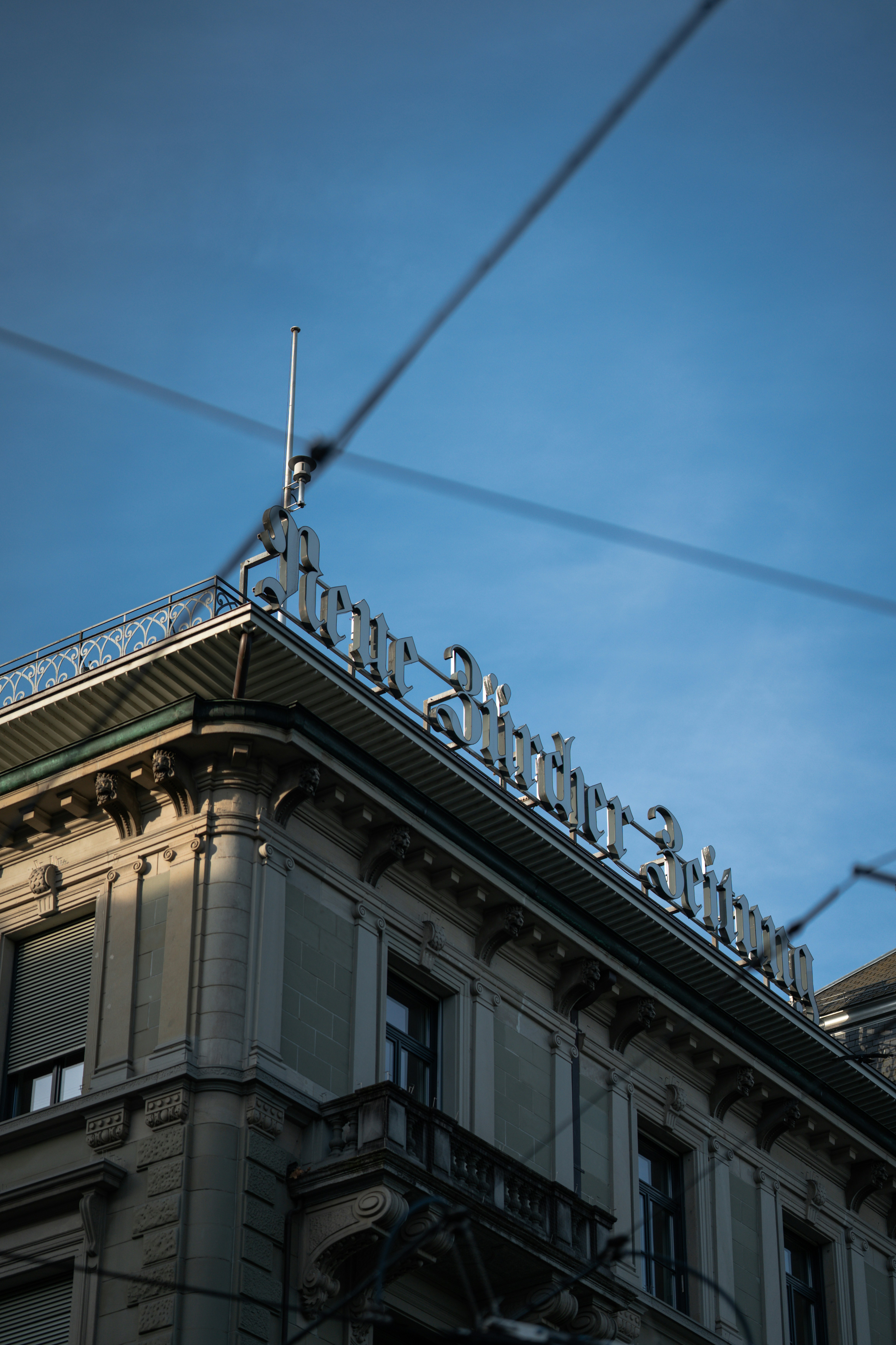 Ornate building with signage against a blue sky.