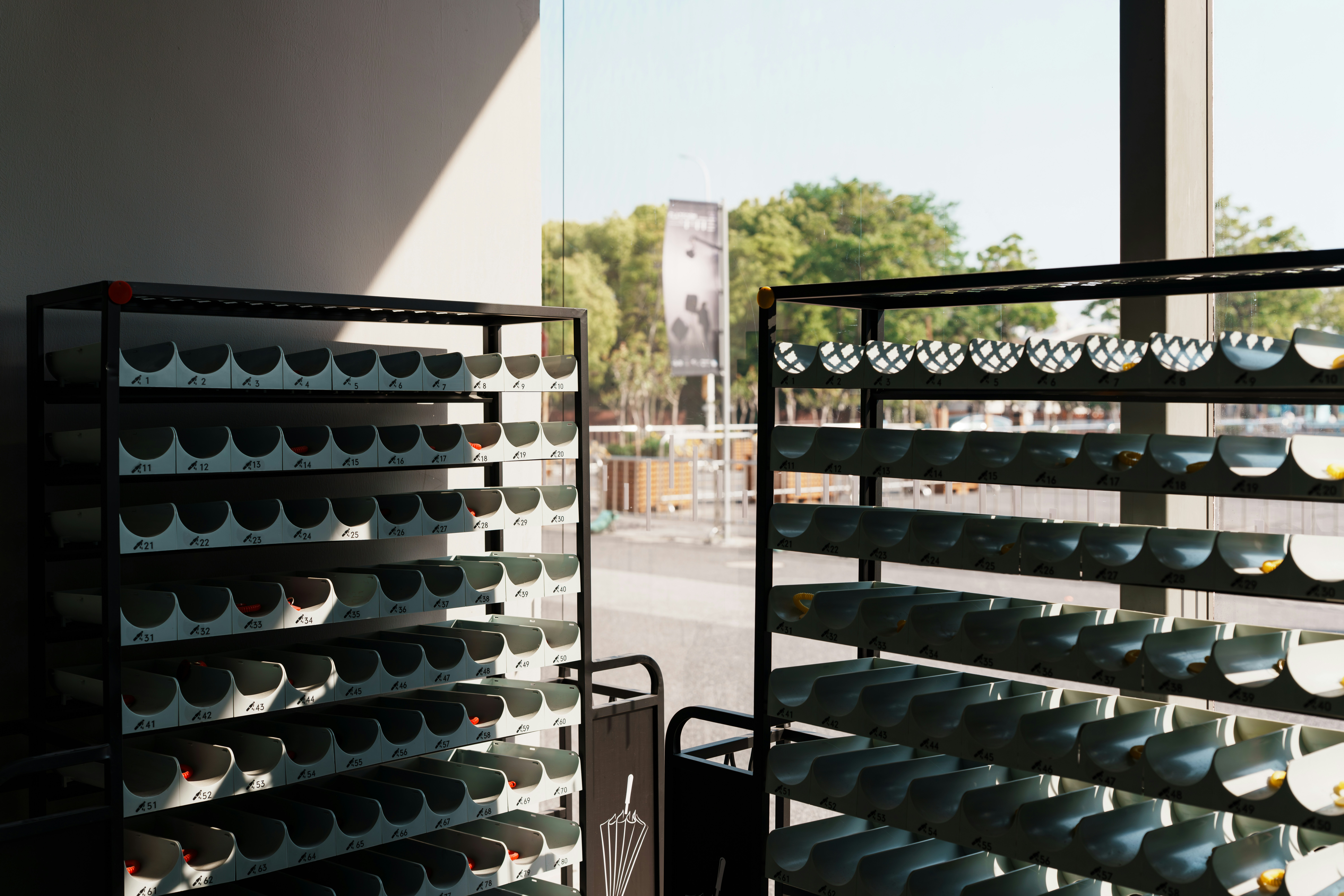 Two shelves of empty cups in a cafe