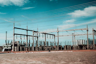 Electrical substation with power lines against blue sky