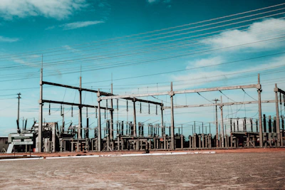Electrical substation with power lines against blue sky
