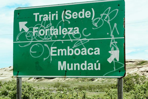 Green road sign with destinations trairi, fortaleza, emboaca, and mundaú