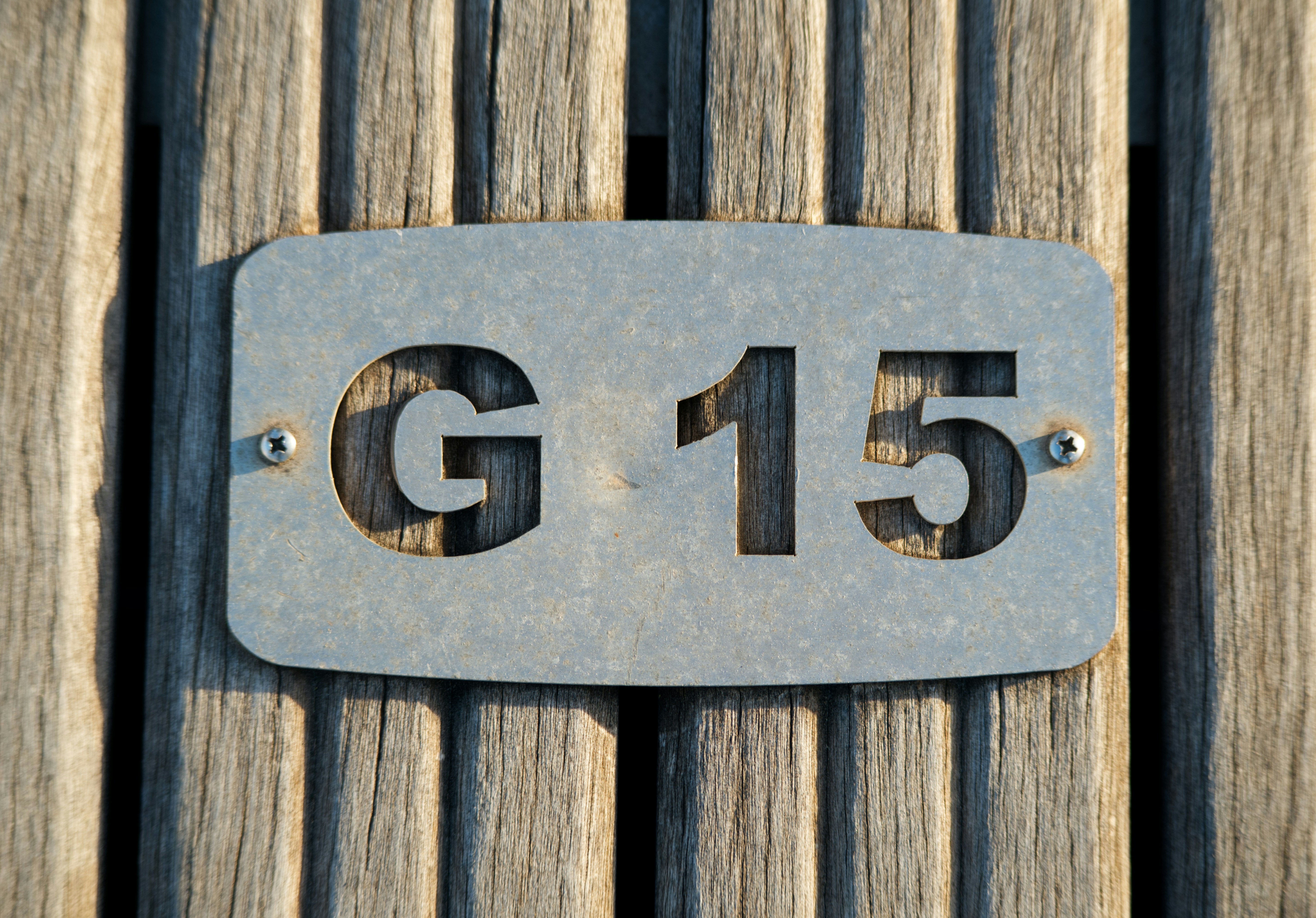 Metal plate with g 15 designation on wooden planks