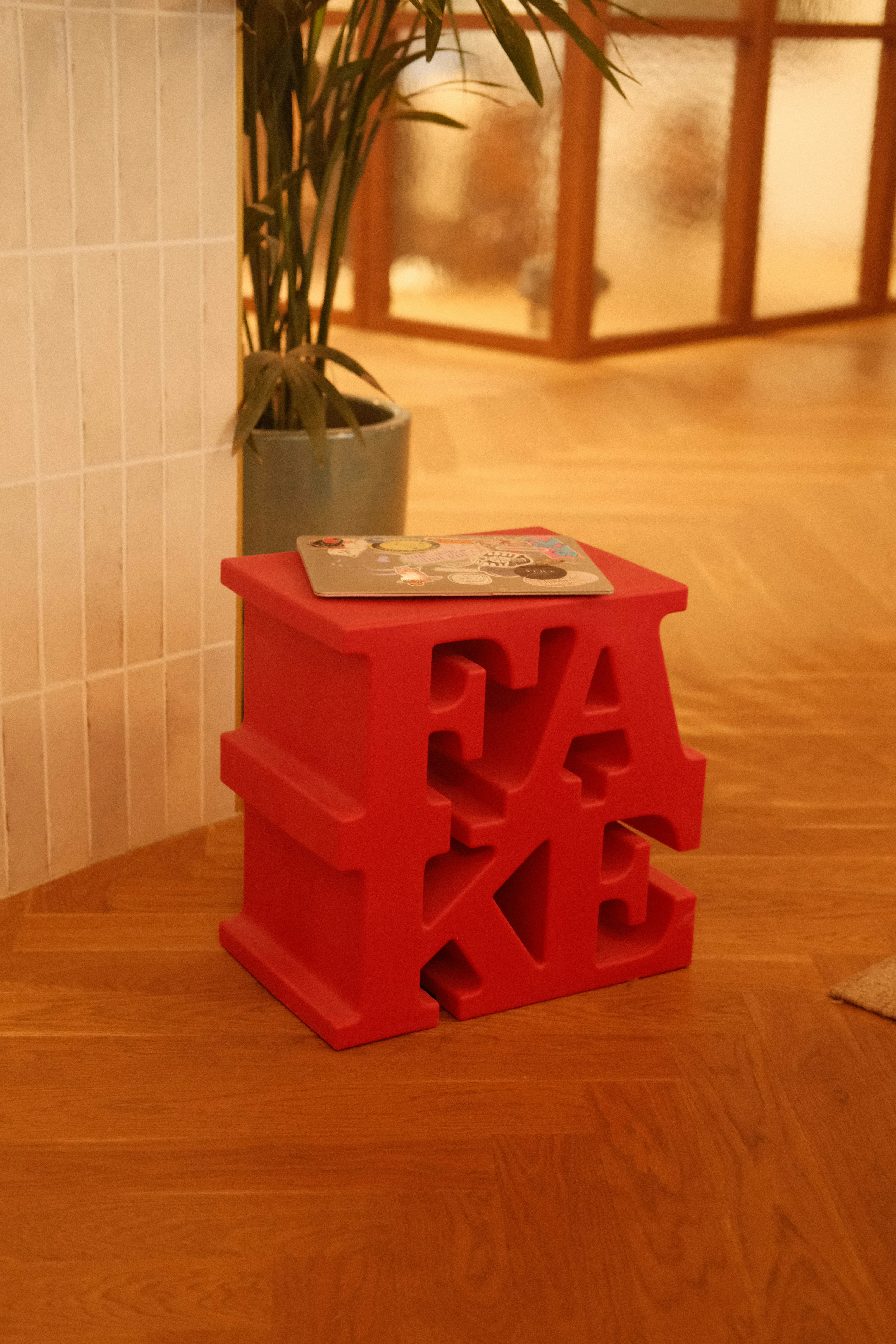 Red stool with letters forming the word 'cake'