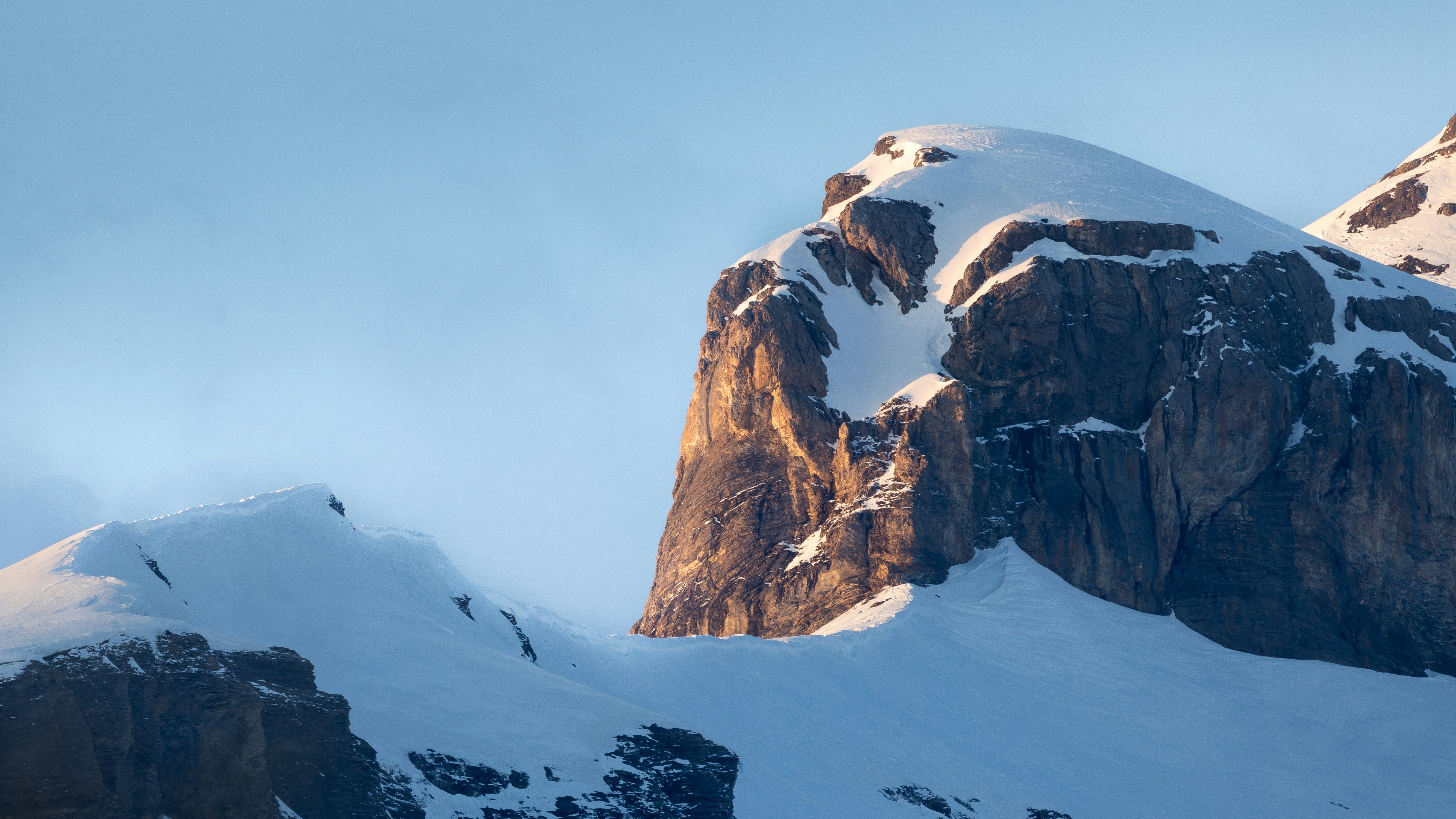 Snow-capped mountains under a clear blue sky.