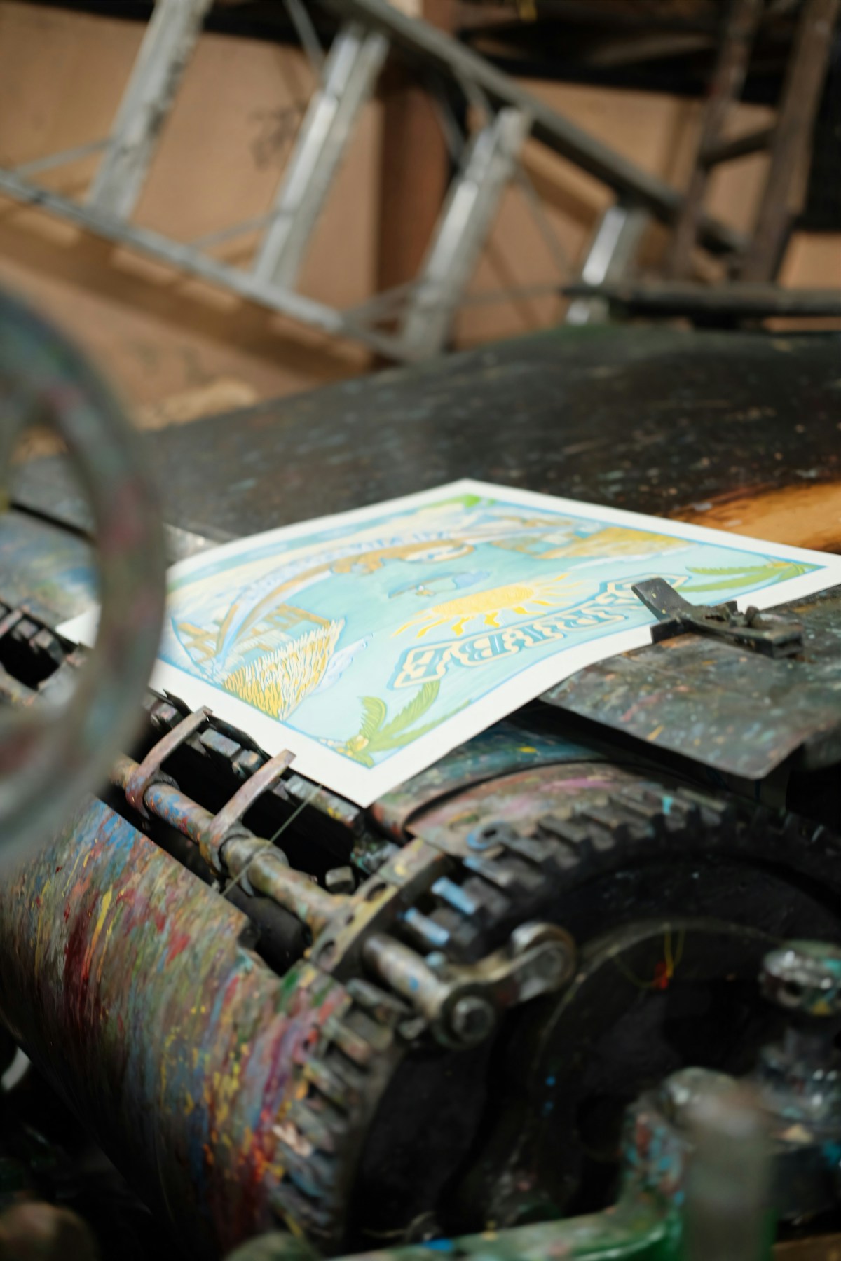 A colorful print resting on an old printing press