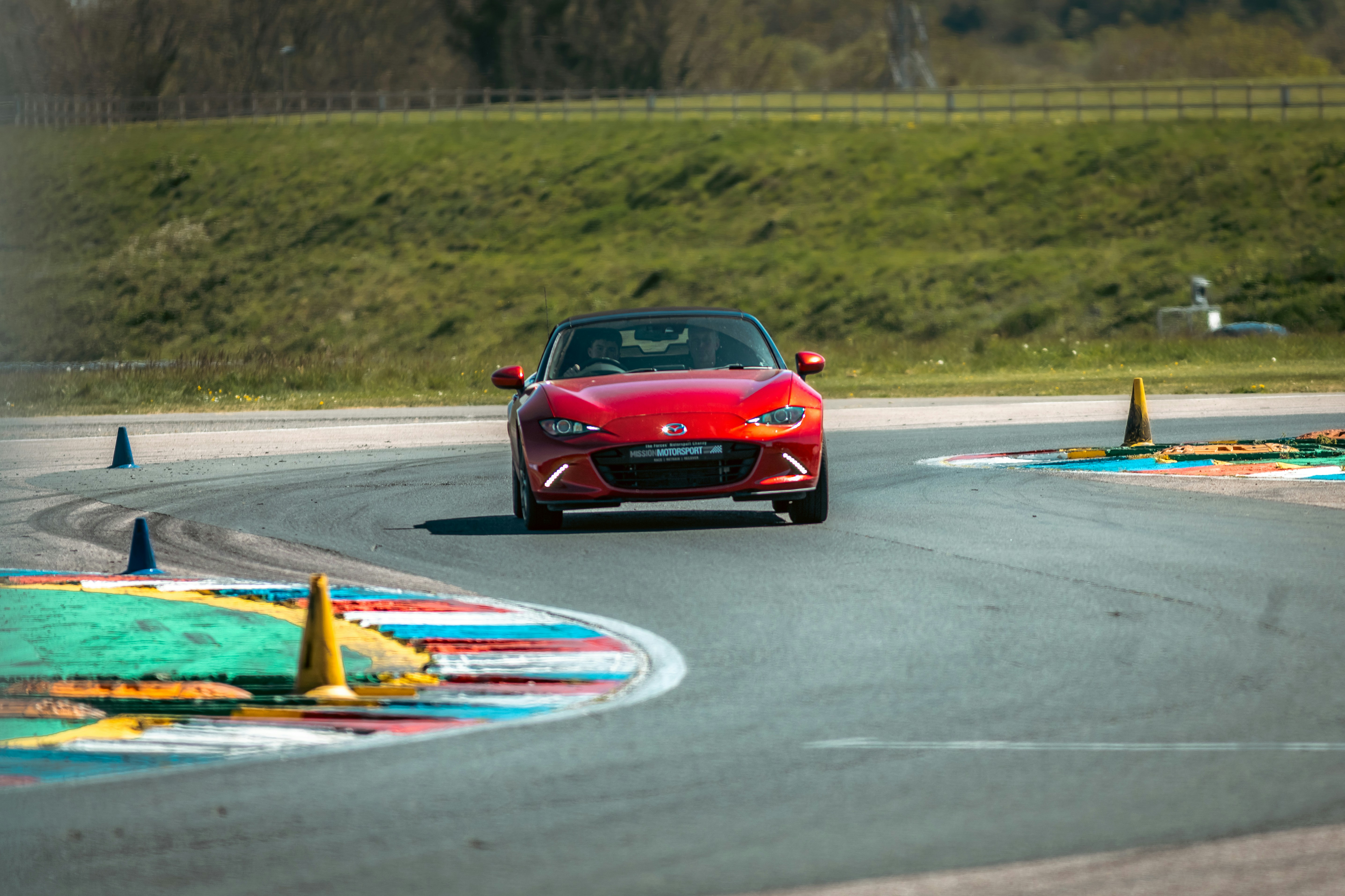Red car driving on a race track photo – Free Sports car Image on Unsplash