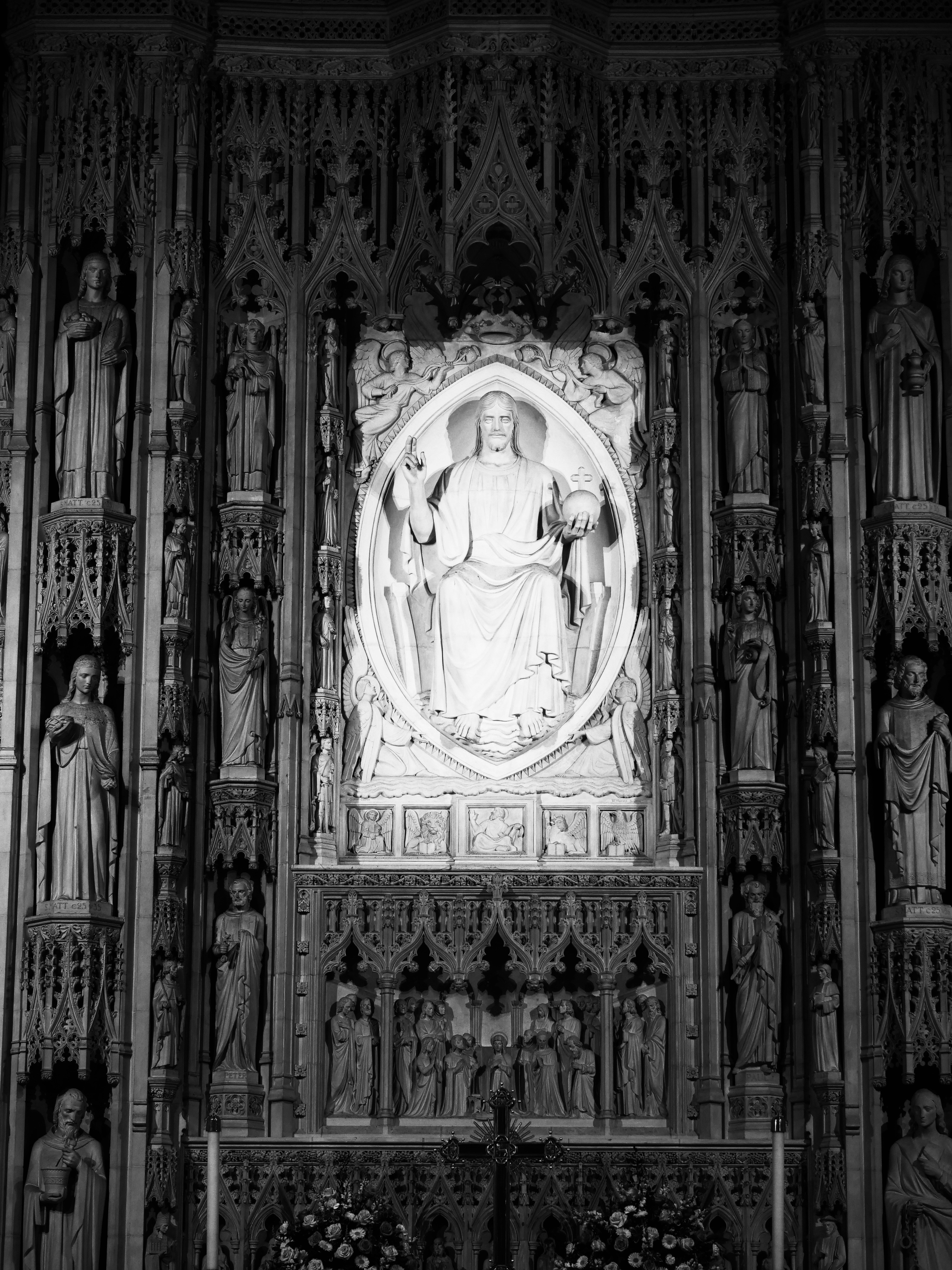 Ornate religious monument with seated figure and statues