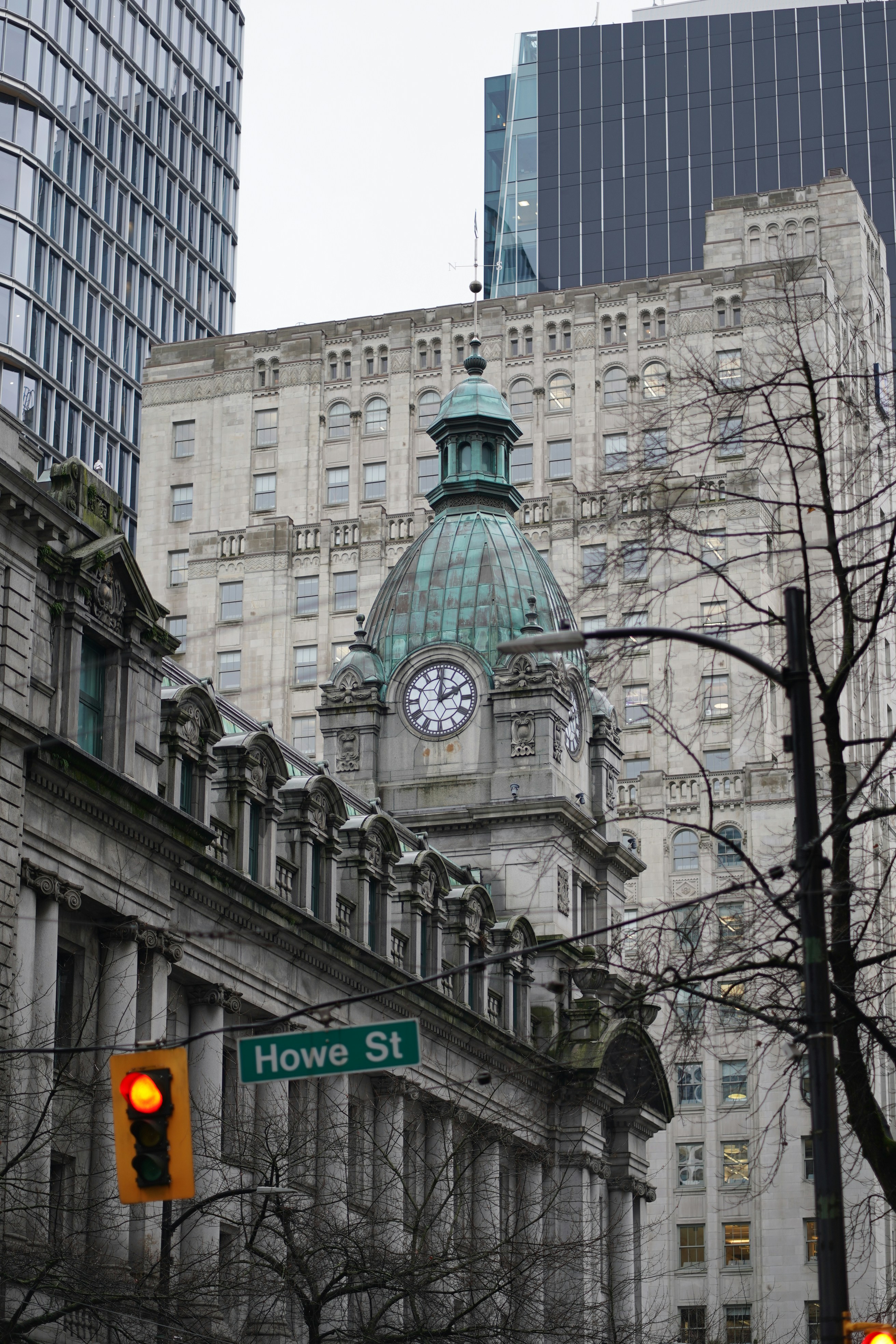 Historic building with clock tower and street sign