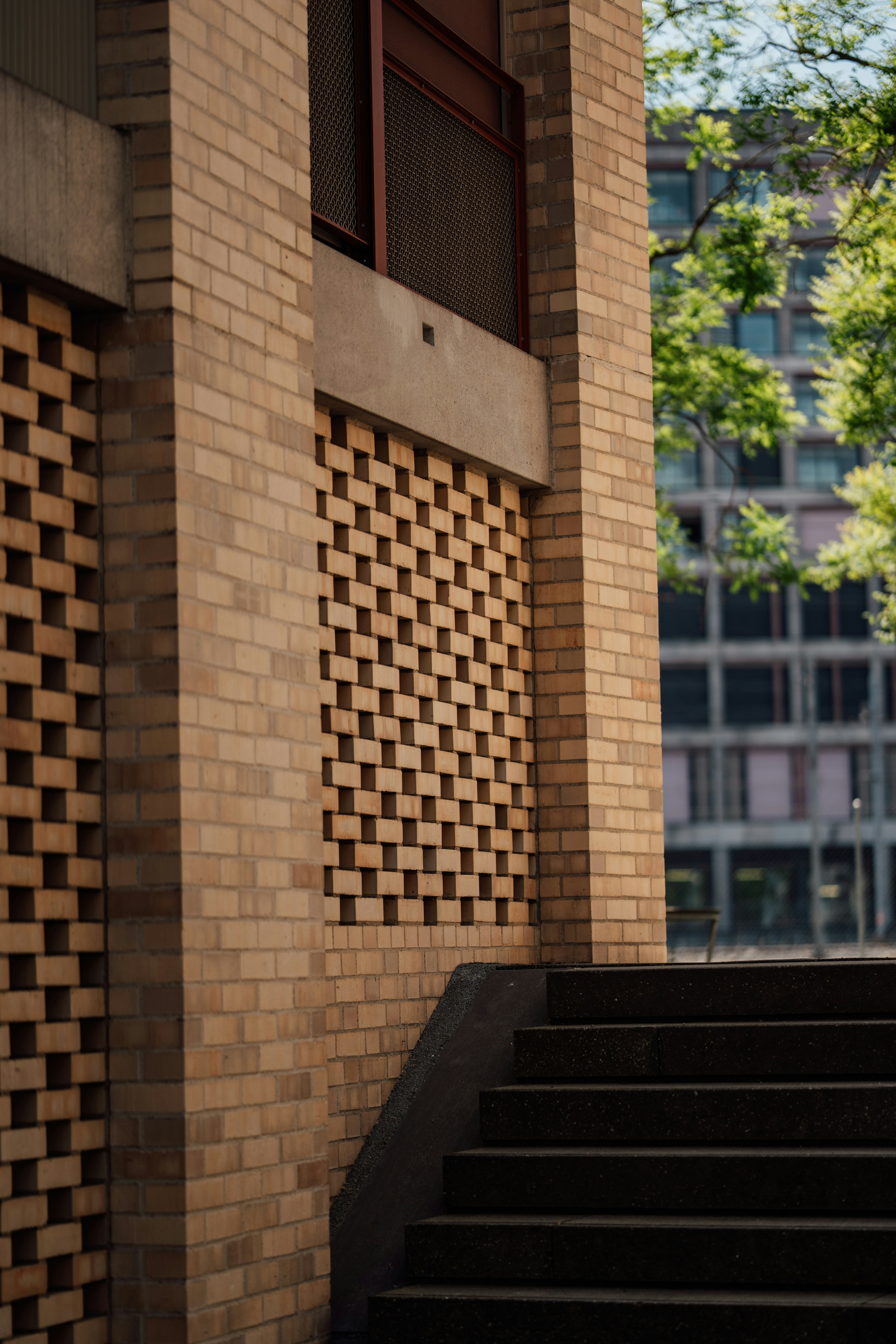 A brick building with a decorative pattern and stairs.