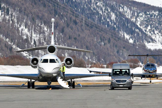Private jets and van on snowy airport tarmac