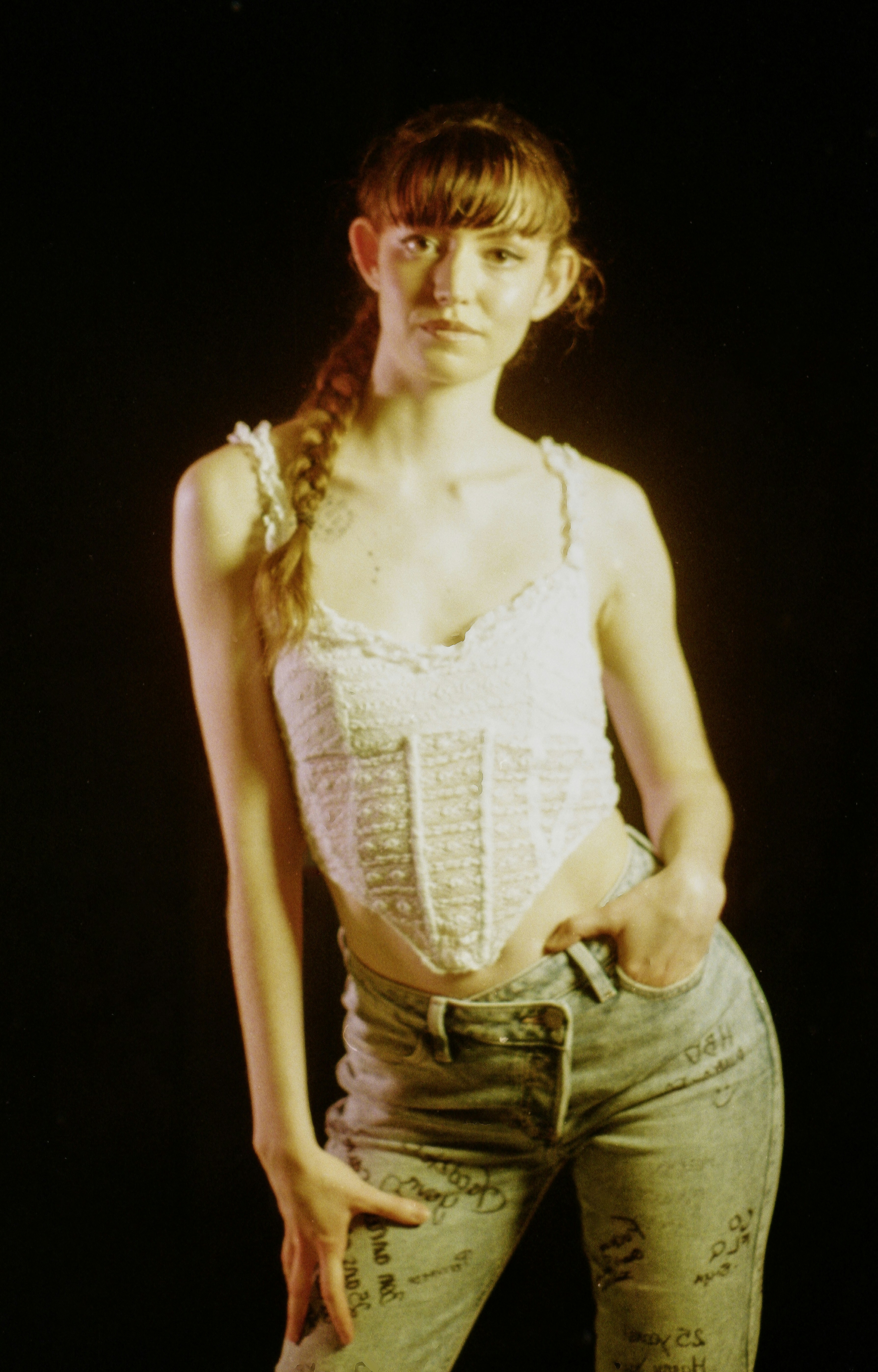 Young woman in white corset top and patterned jeans