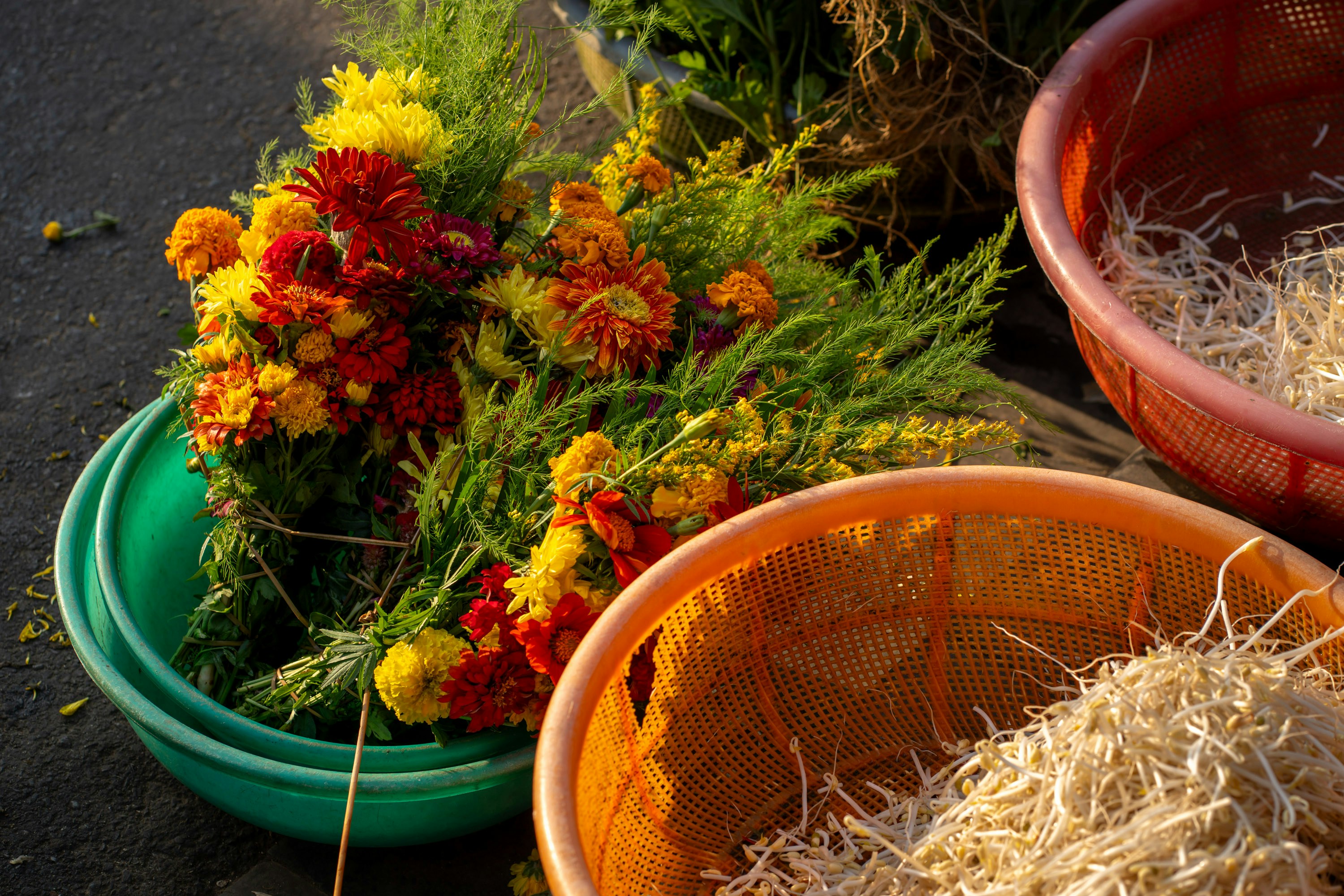 Colorful flowers in green bowl with dry goods