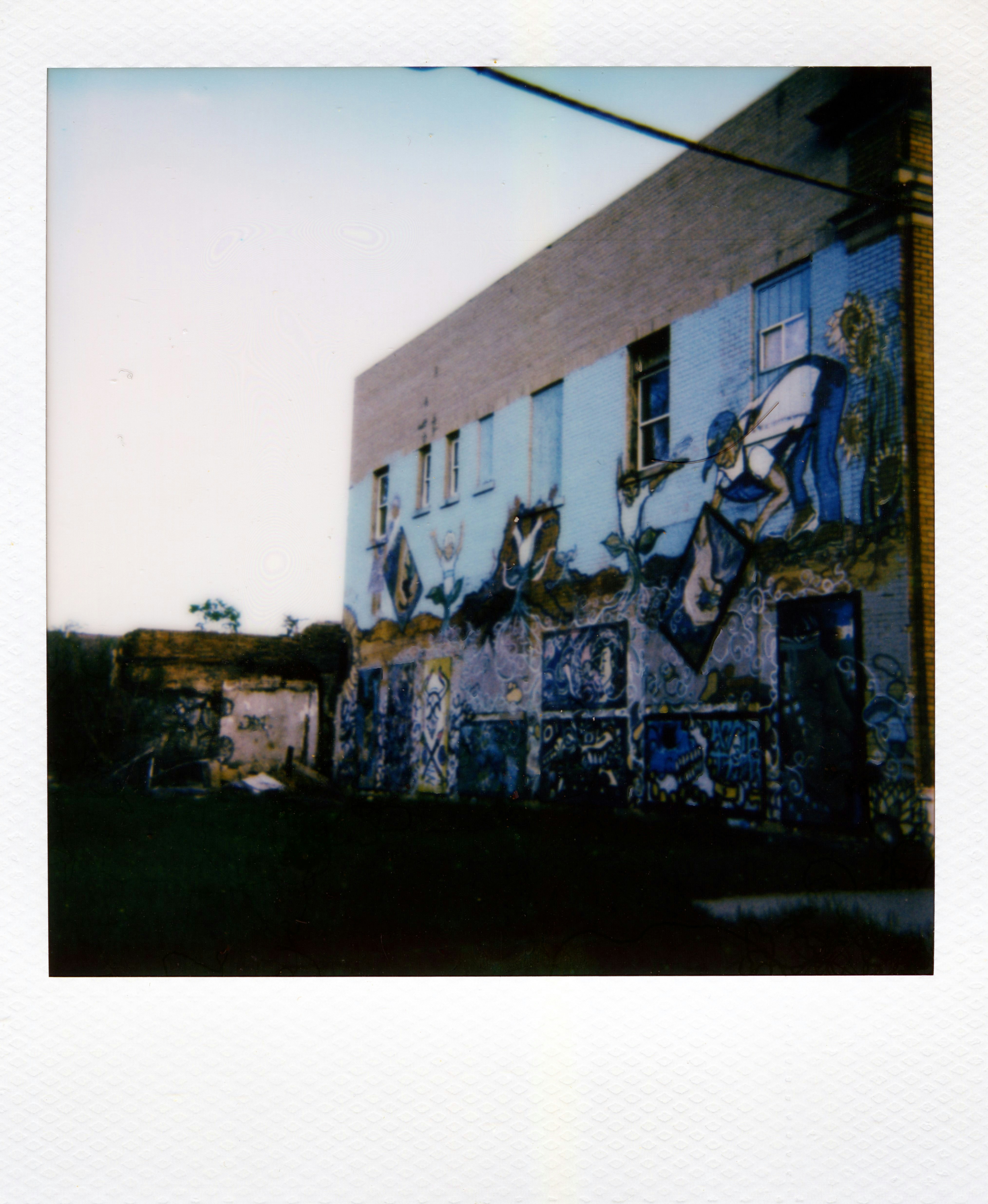 Building with blue mural art on exterior wall