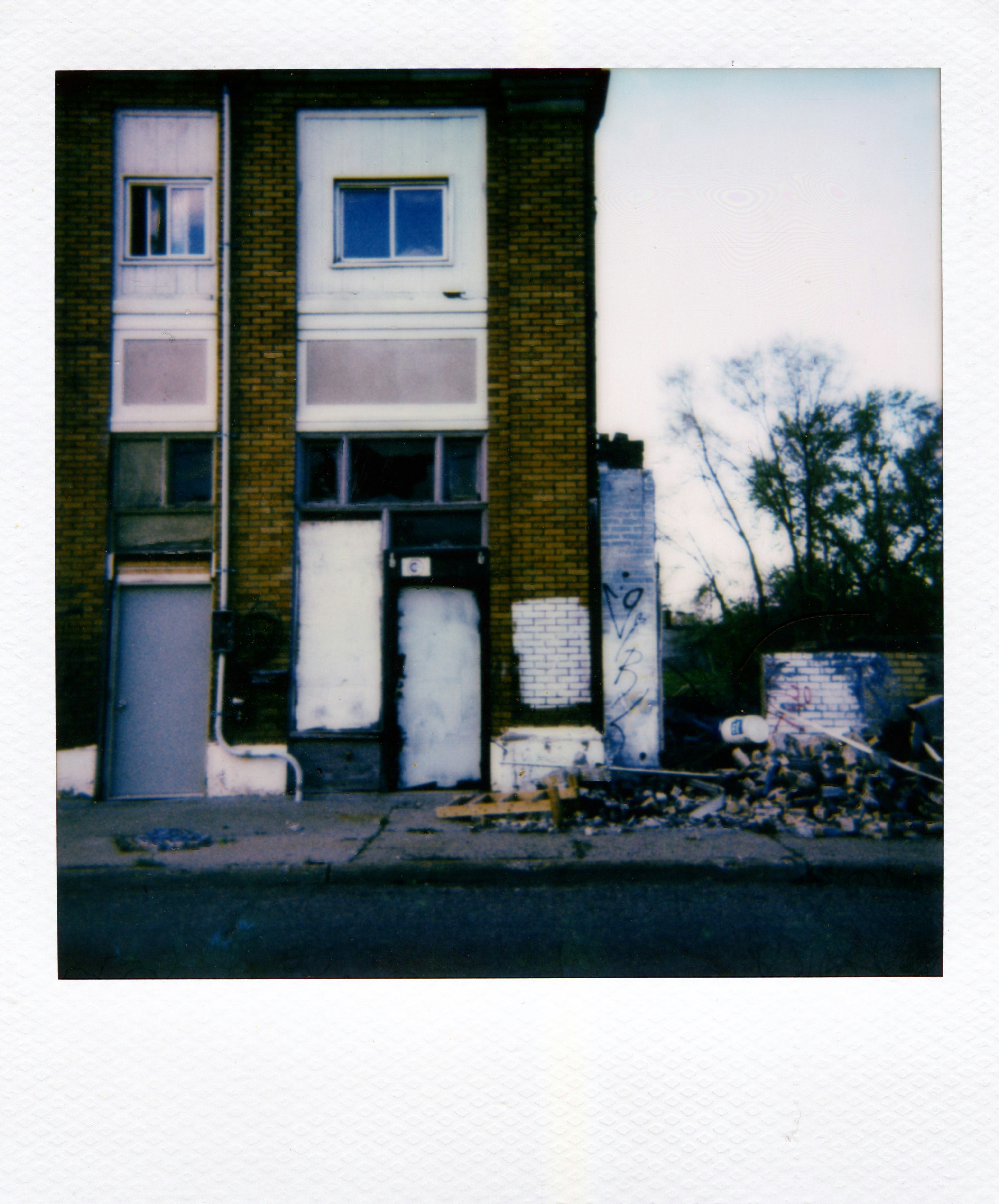 Brick building with doors and debris outside debris
