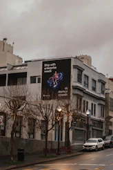 Building with a large advertisement on its side.