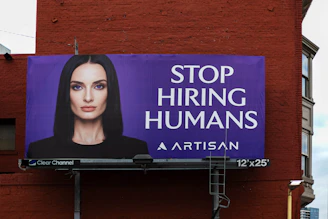 Billboard with woman and text "stop hiring humans"