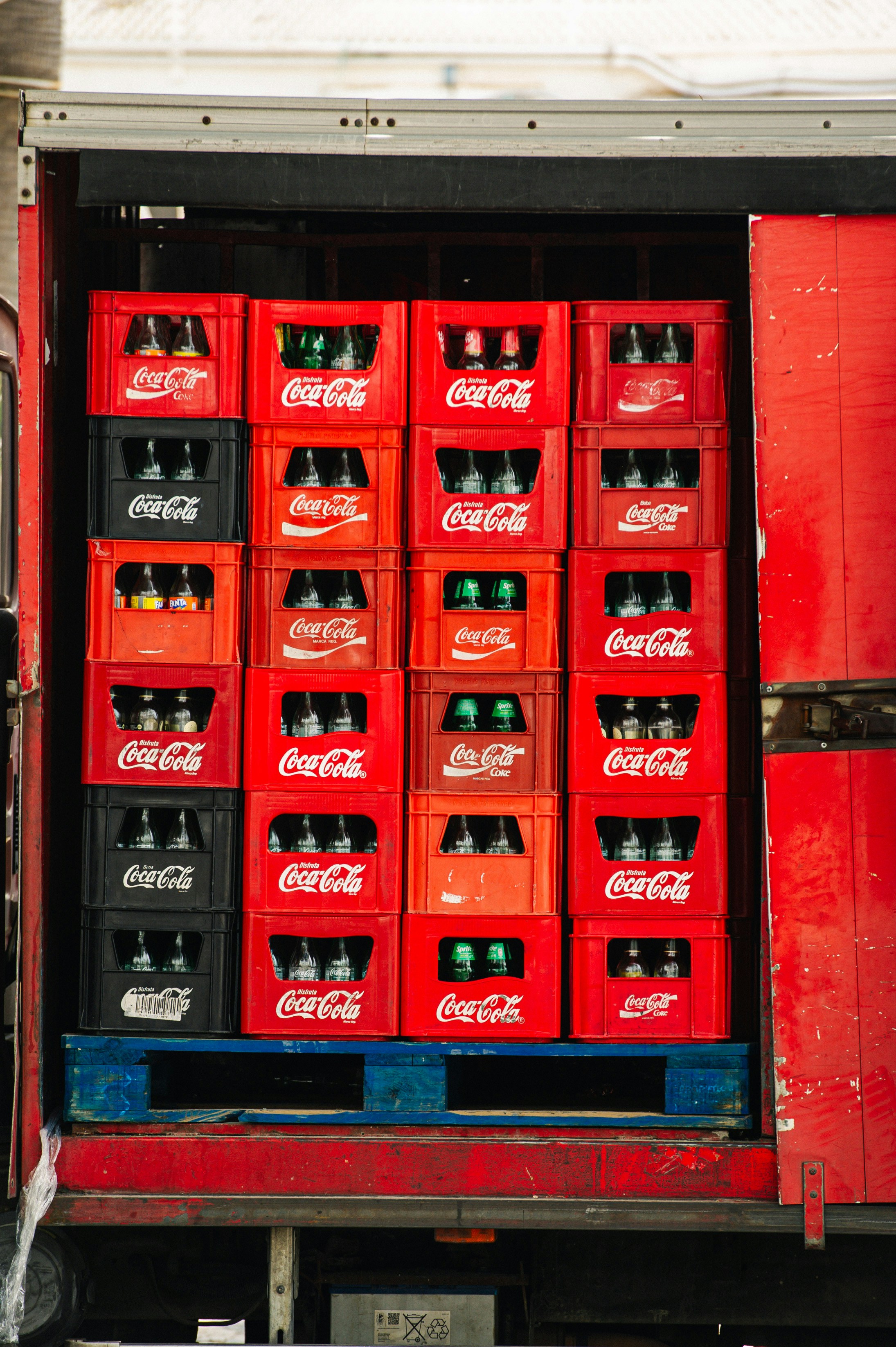 Pilha de caixas de Coca-Cola carregadas em um caminhão vermelho