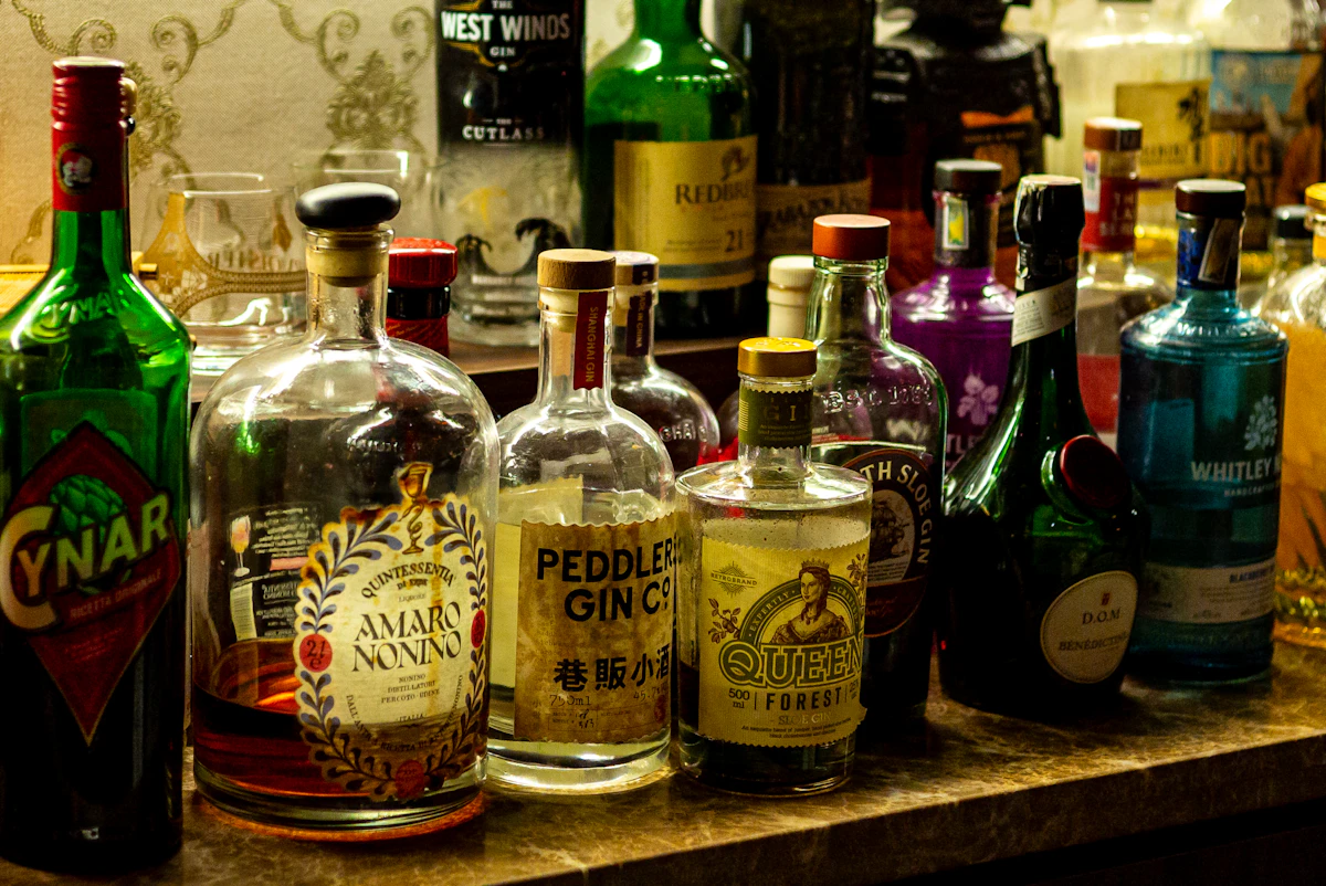 Real assortment of spirits and cocktail mixing ingredients on shelves