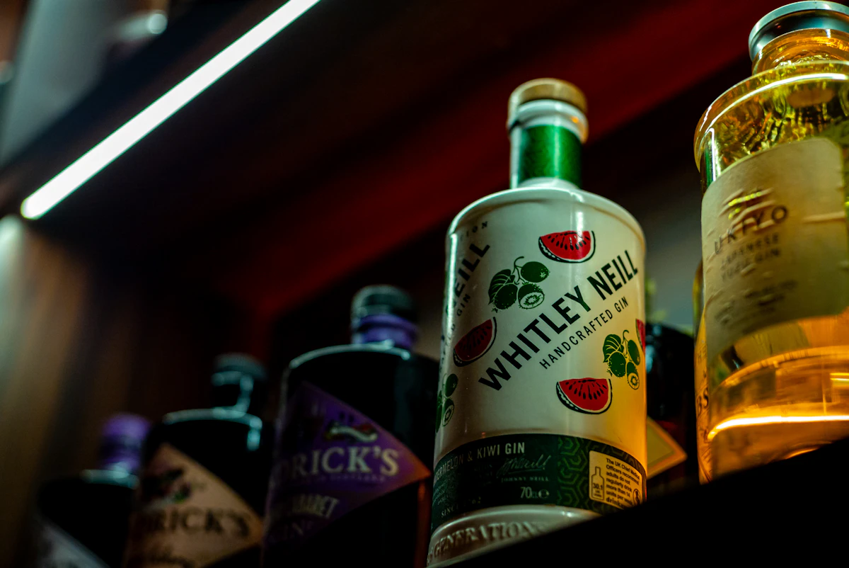 Real gin bottles arranged on a bar shelf