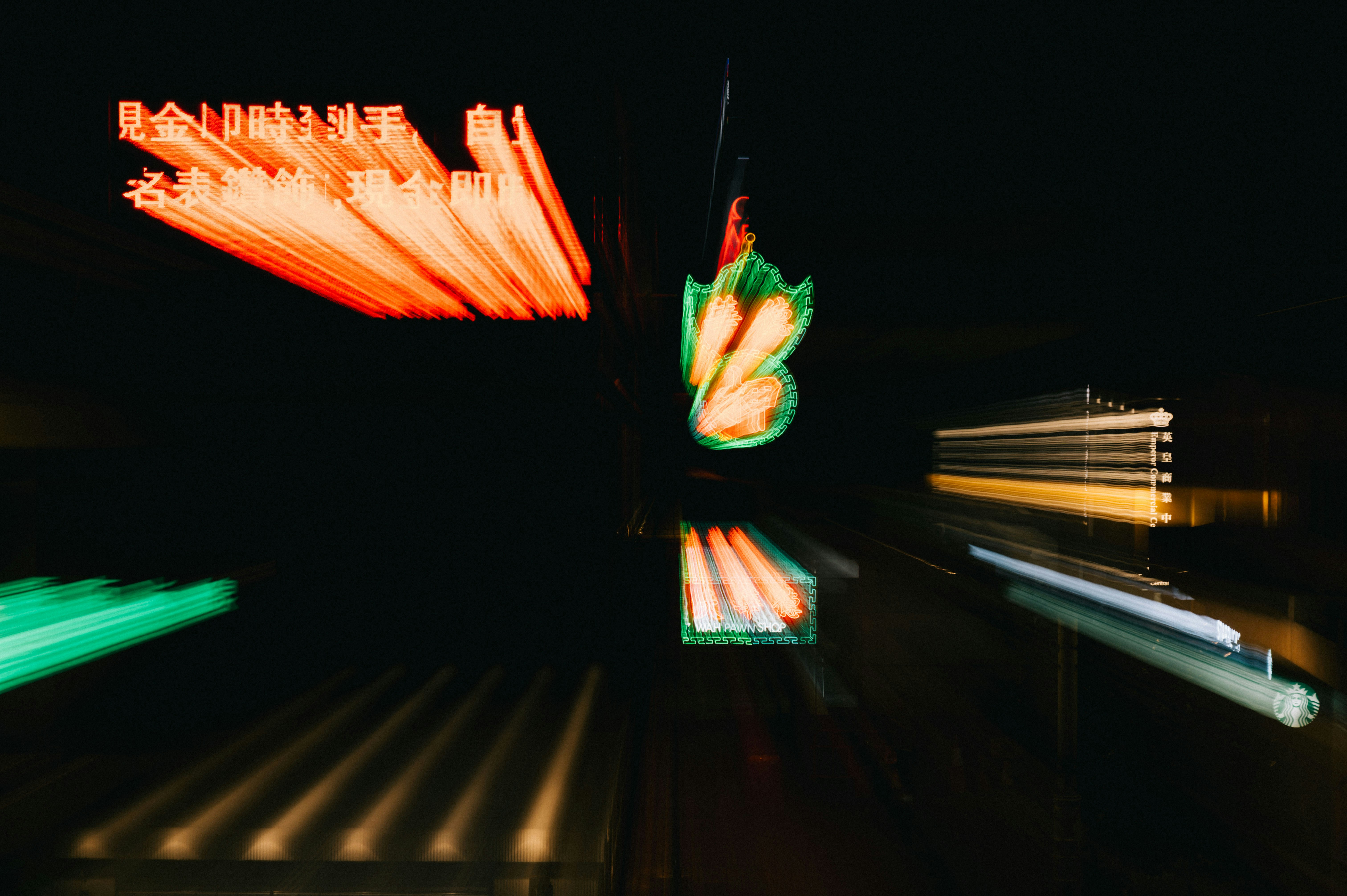Blurred neon lights and street signs at night